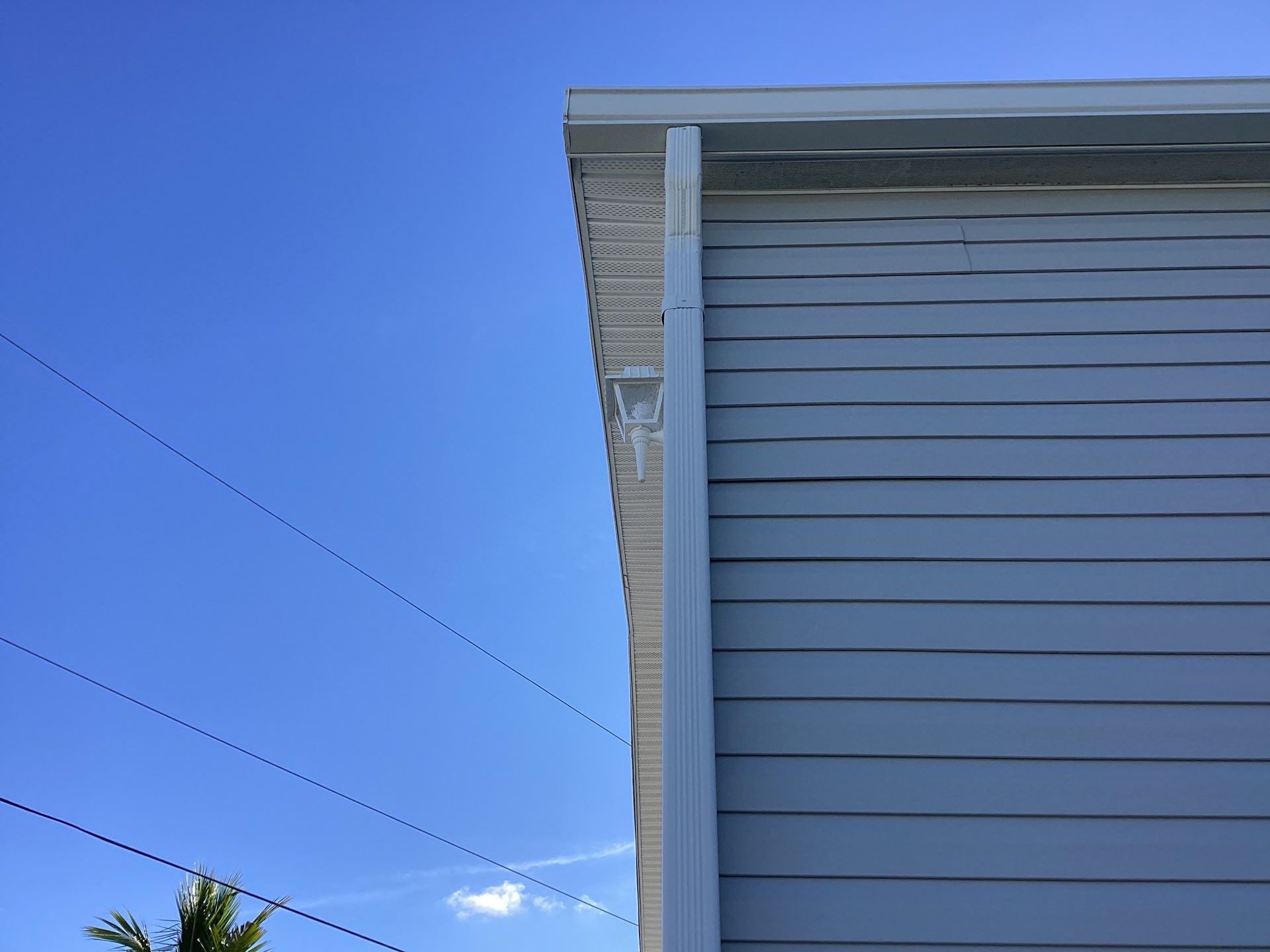White Downspouts Installation in St. James City by Gutter Professors