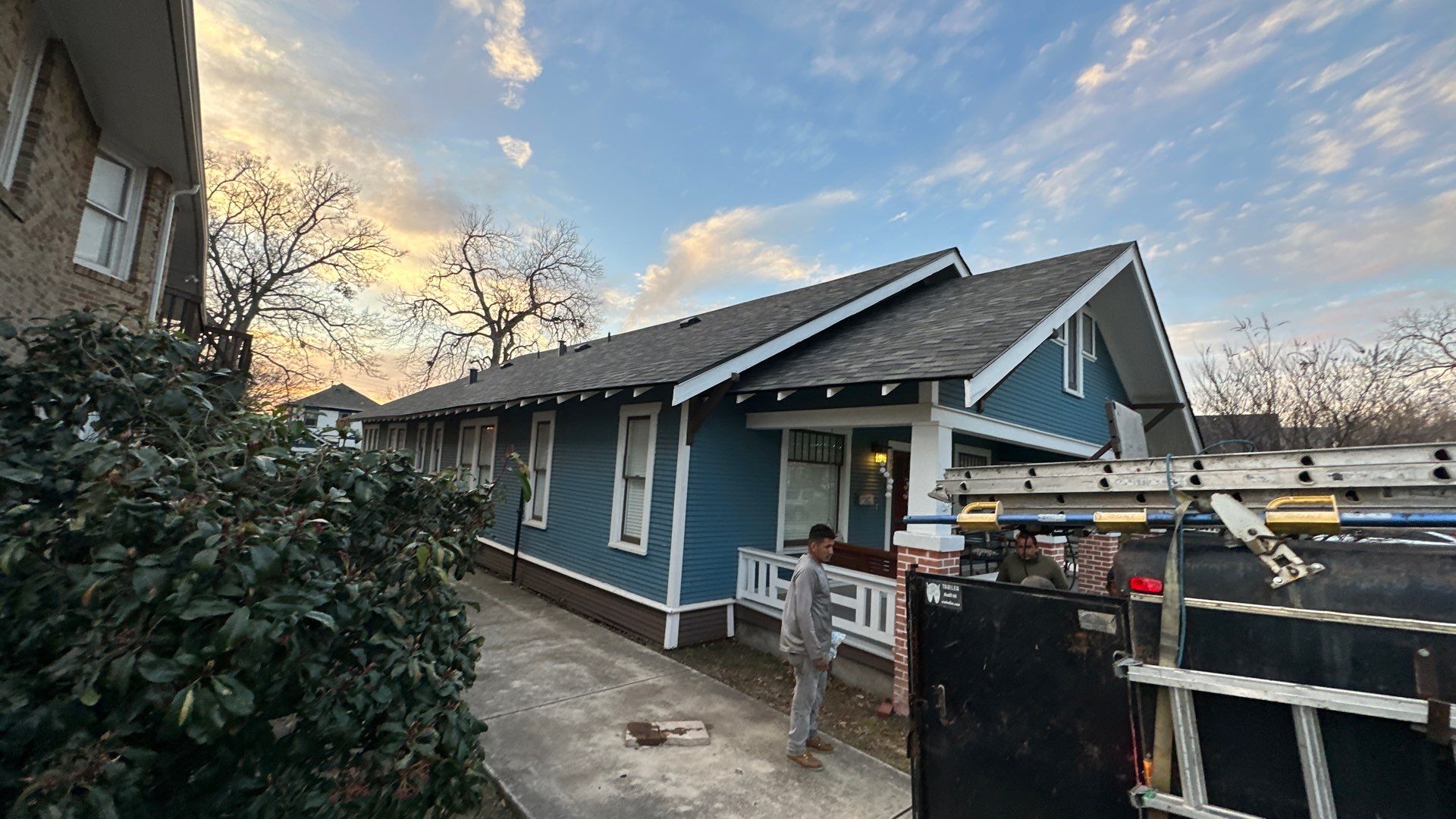 Blue sliding/brick columns on the porch with Malarkey Storm Grey by Tejas Roofworks + Restoration