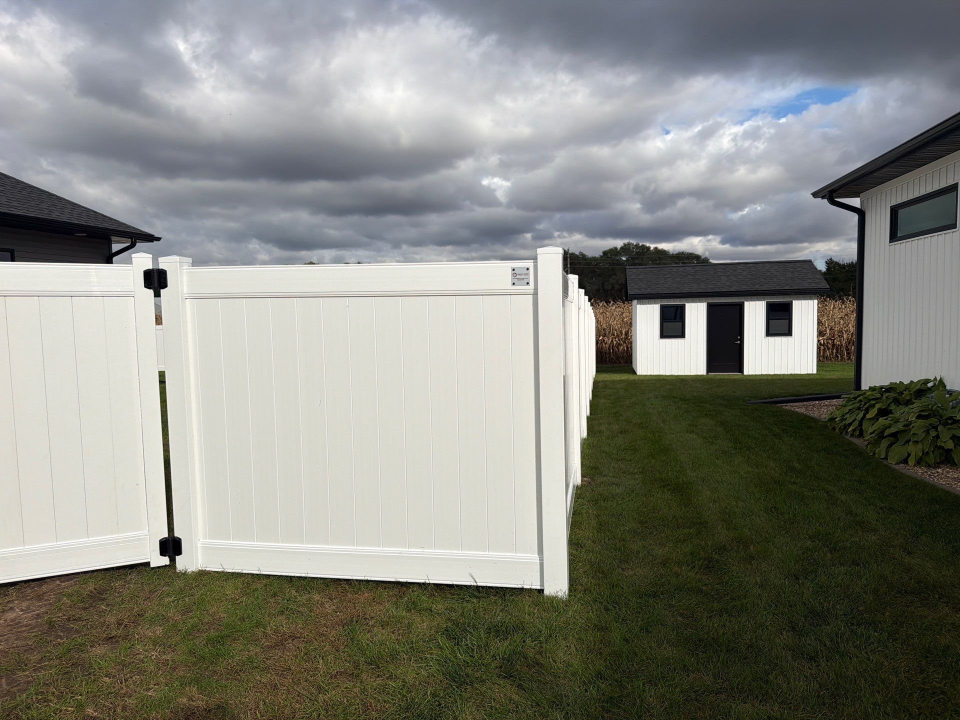 Residential White Vinyl Privacy Fence Installation in Janesville by Perfect Picket Fence and Stain