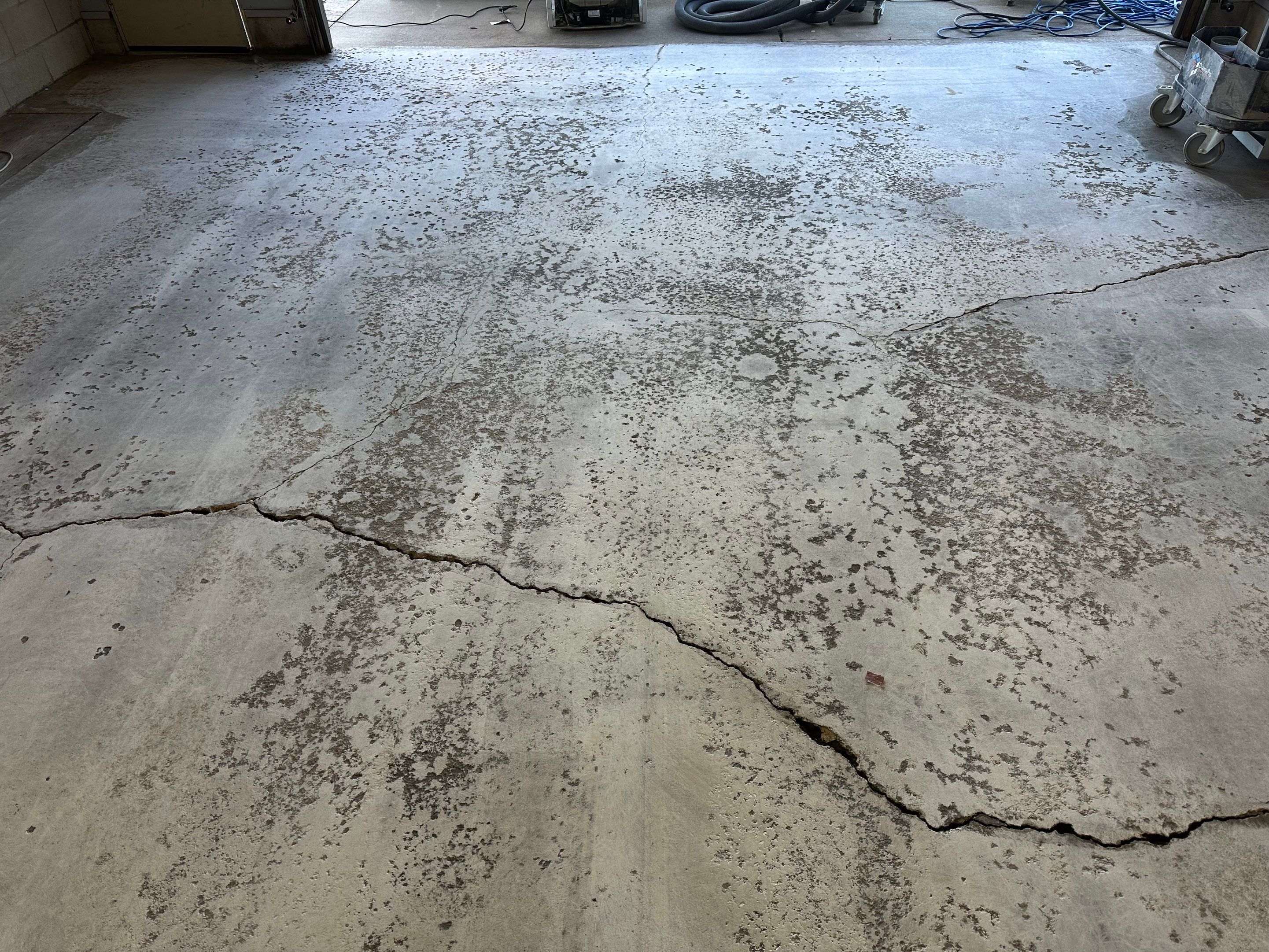 Multi-Colored Speckled Concrete Floor Coating Installation in Sioux Falls by Select Painting, Coatings & Garage Cabinets