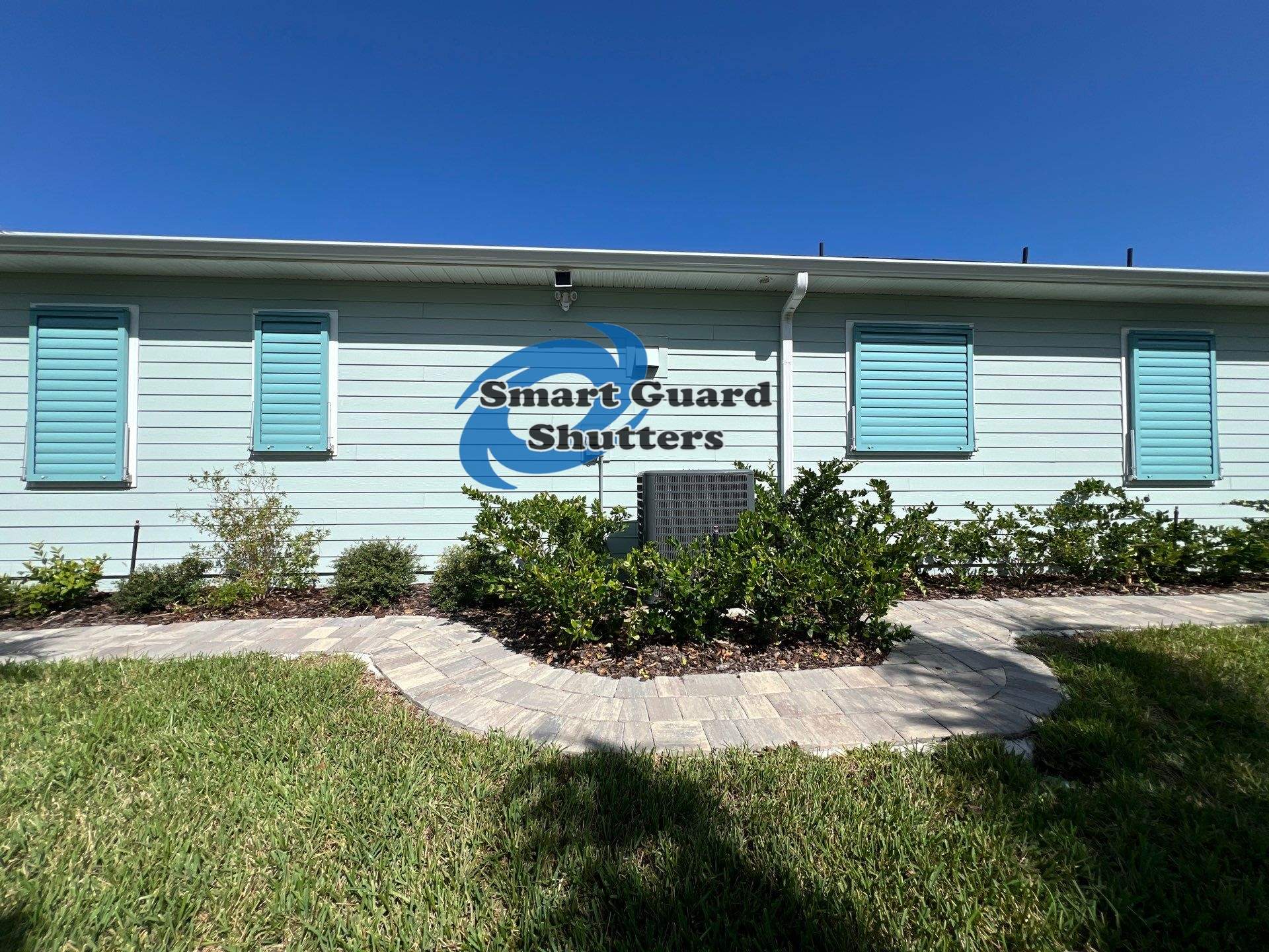 Impact Bahama Shutters in Pastel Turquoise by Smart Guard Shutters