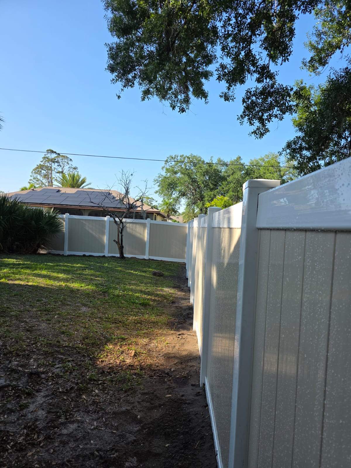 Two-Tone Vinyl Privacy Fence Installation in Port Charlotte by True Fence LLC