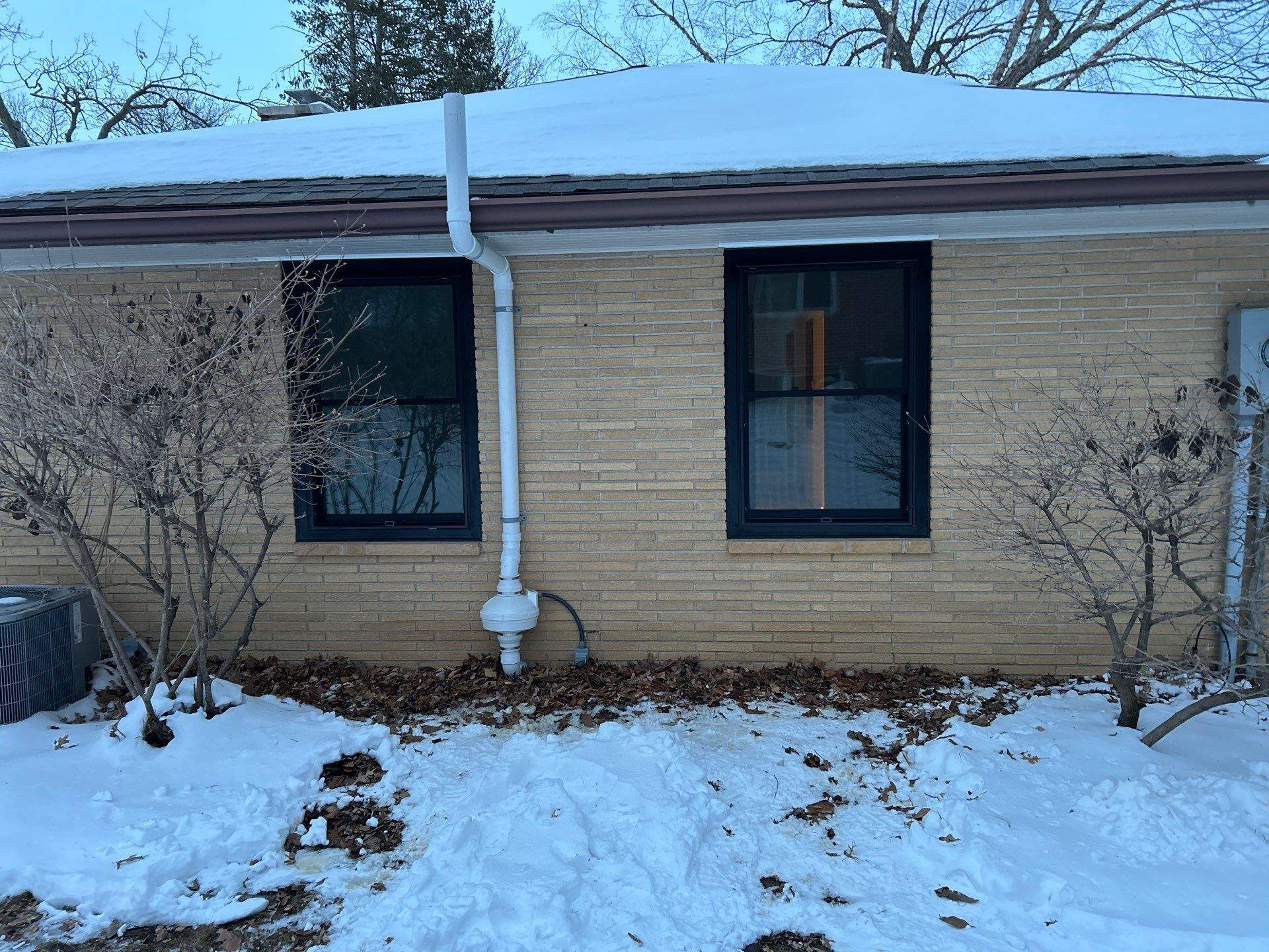 Black-Frame Pella Lifestyle Upgrade on a Partial Brick Home by United Windows and Siding LLC