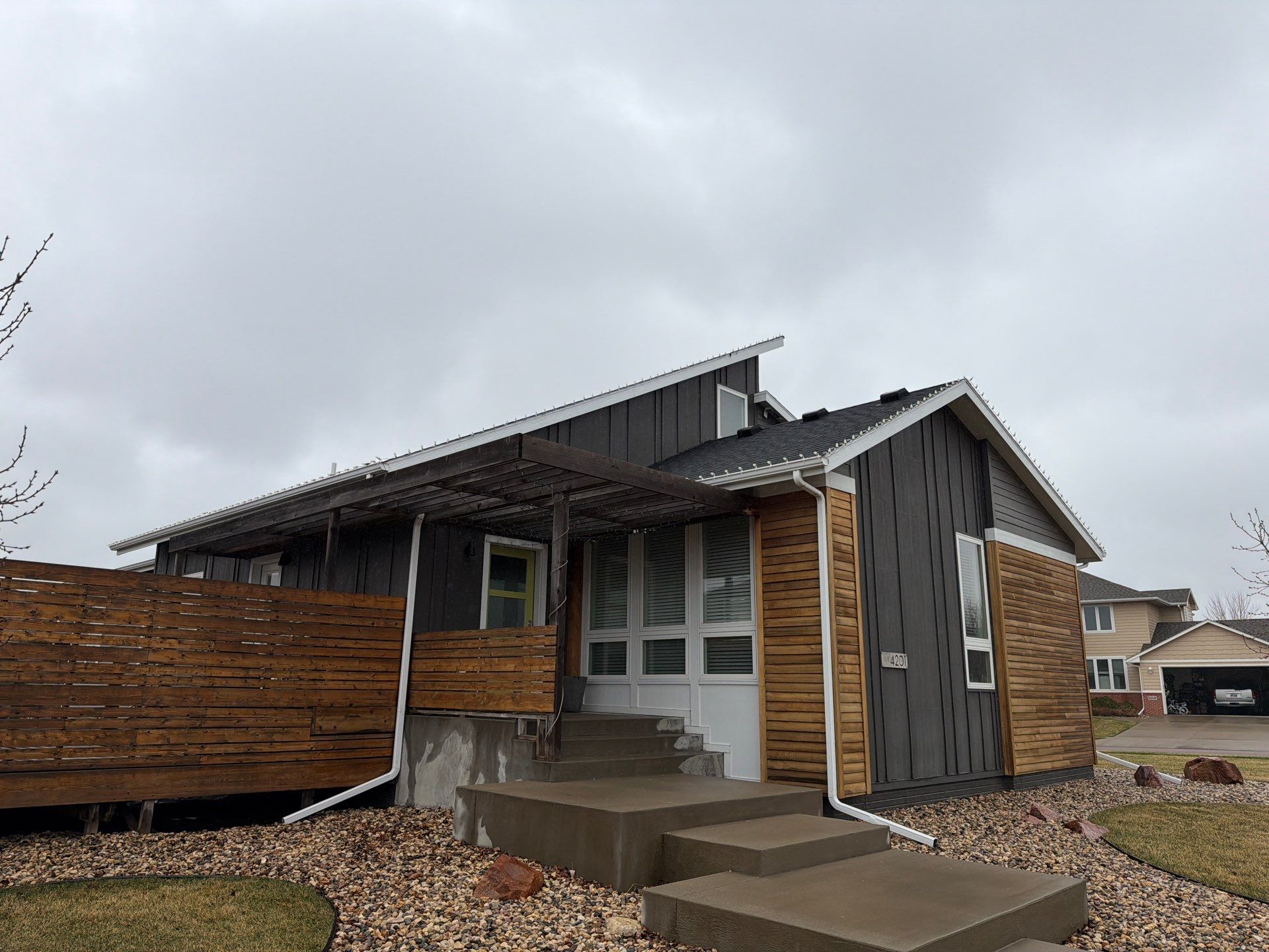 Modern Exterior Transformation Featuring Dark Board and Batten Siding in Sioux Falls by Select Painting, Coatings & Garage Cabinets