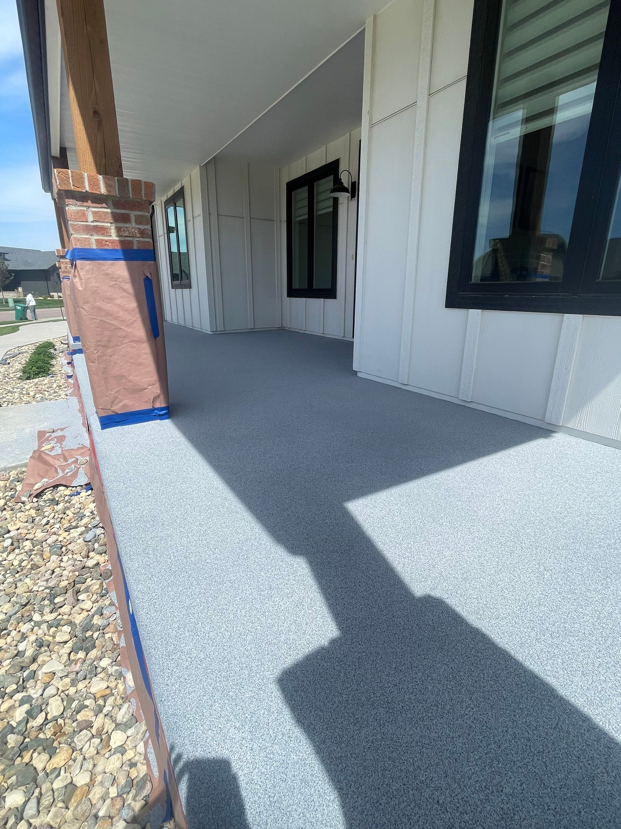 Grey Speckled Concrete Porch Coating for Sioux Falls Home by Select Painting, Coatings & Garage Cabinets
