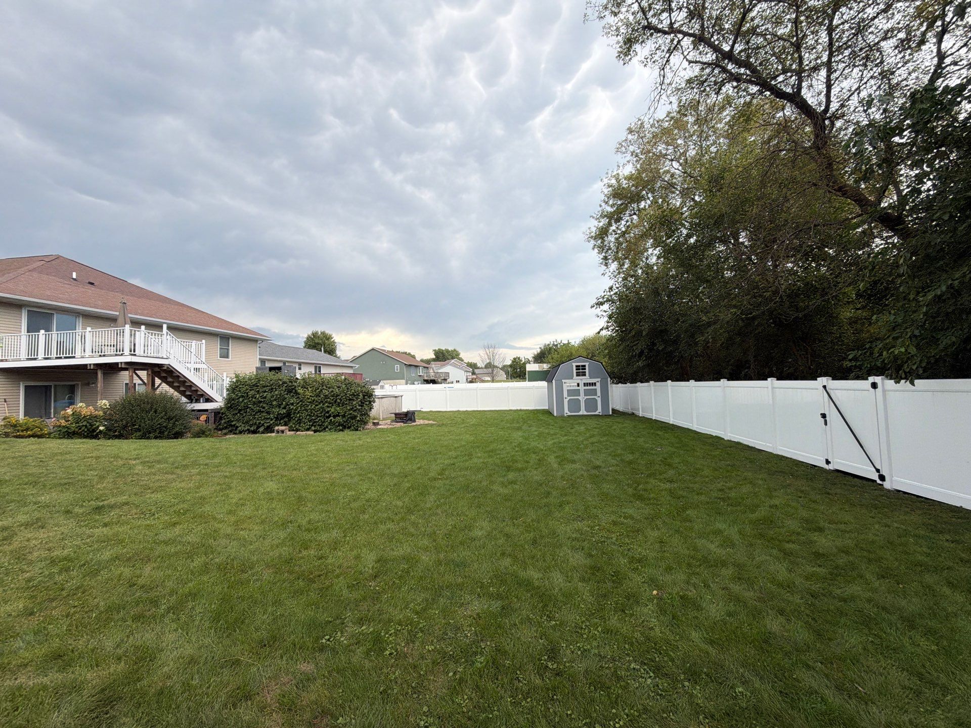 White Vinyl Privacy Fence Installation in Raymond, IA by Perfect Picket Fence and Stain