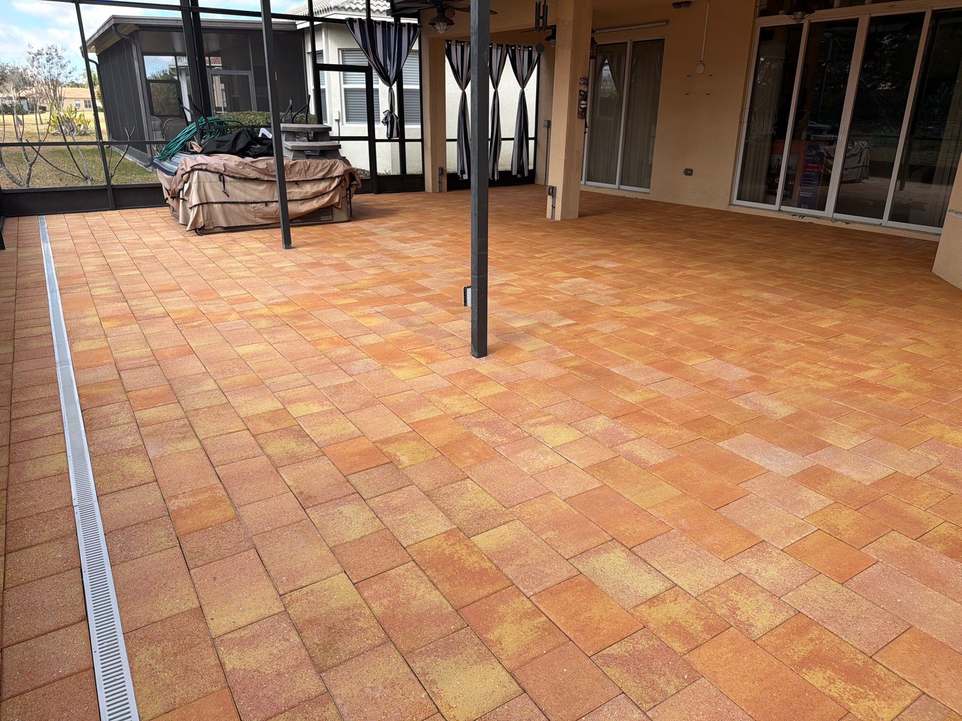 Paver Sealing for Herringbone Driveway and Screened Lanai in Valencia Lakes by Supreme Paver Experts