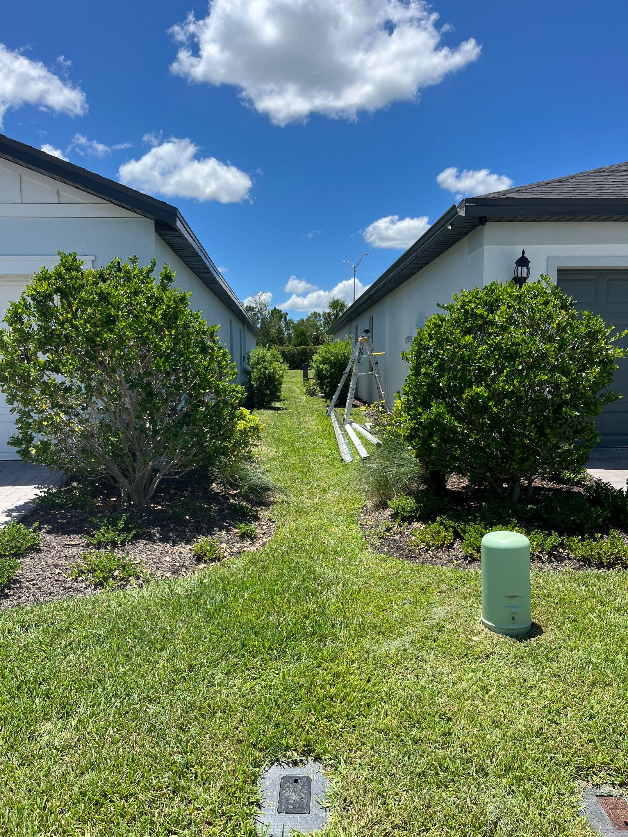 Dark Bronze Gutters and White Downspouts in Sarasota FL by Gutter Professors