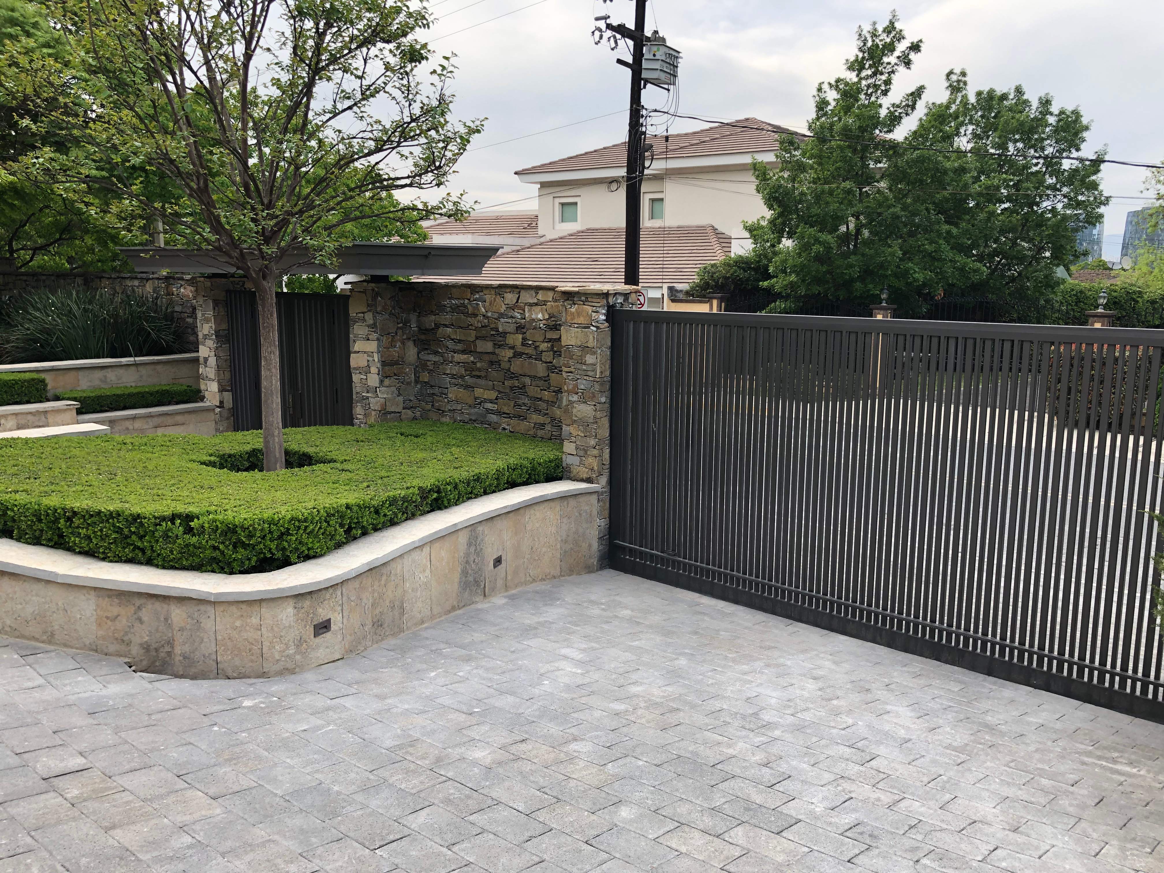 Custom Stone Entryway and Secure Perimeter Gate Installation in Monterrey by Solara Custom Living