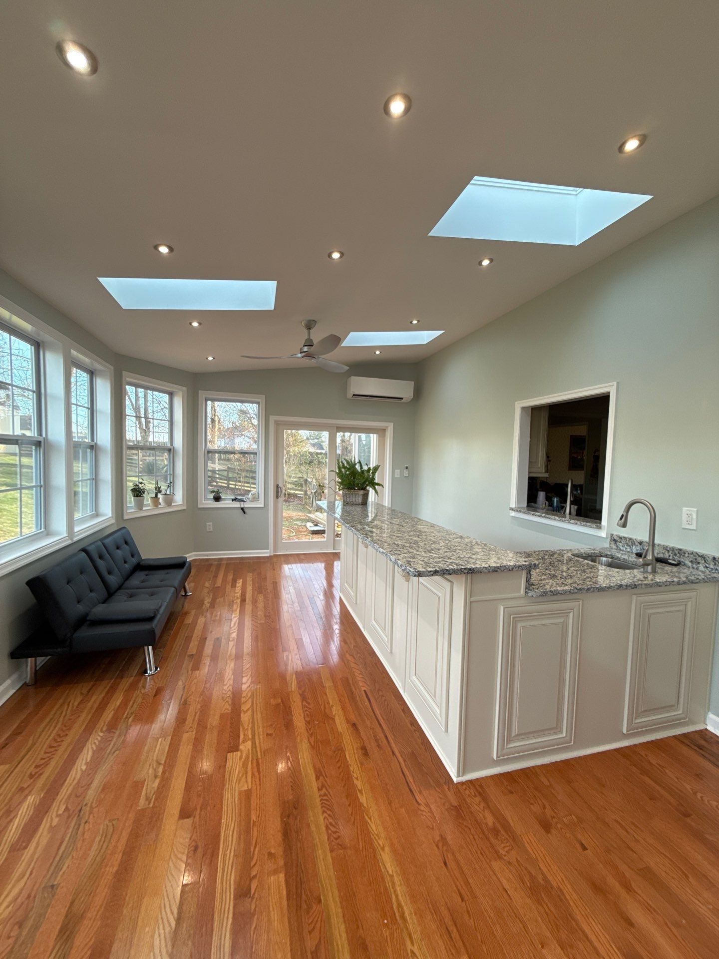 Sun room  using Concrete wood lumber, insulation , drywall, painting , cabinets , laminate floor  . by Jesus Master Handyman LLC 