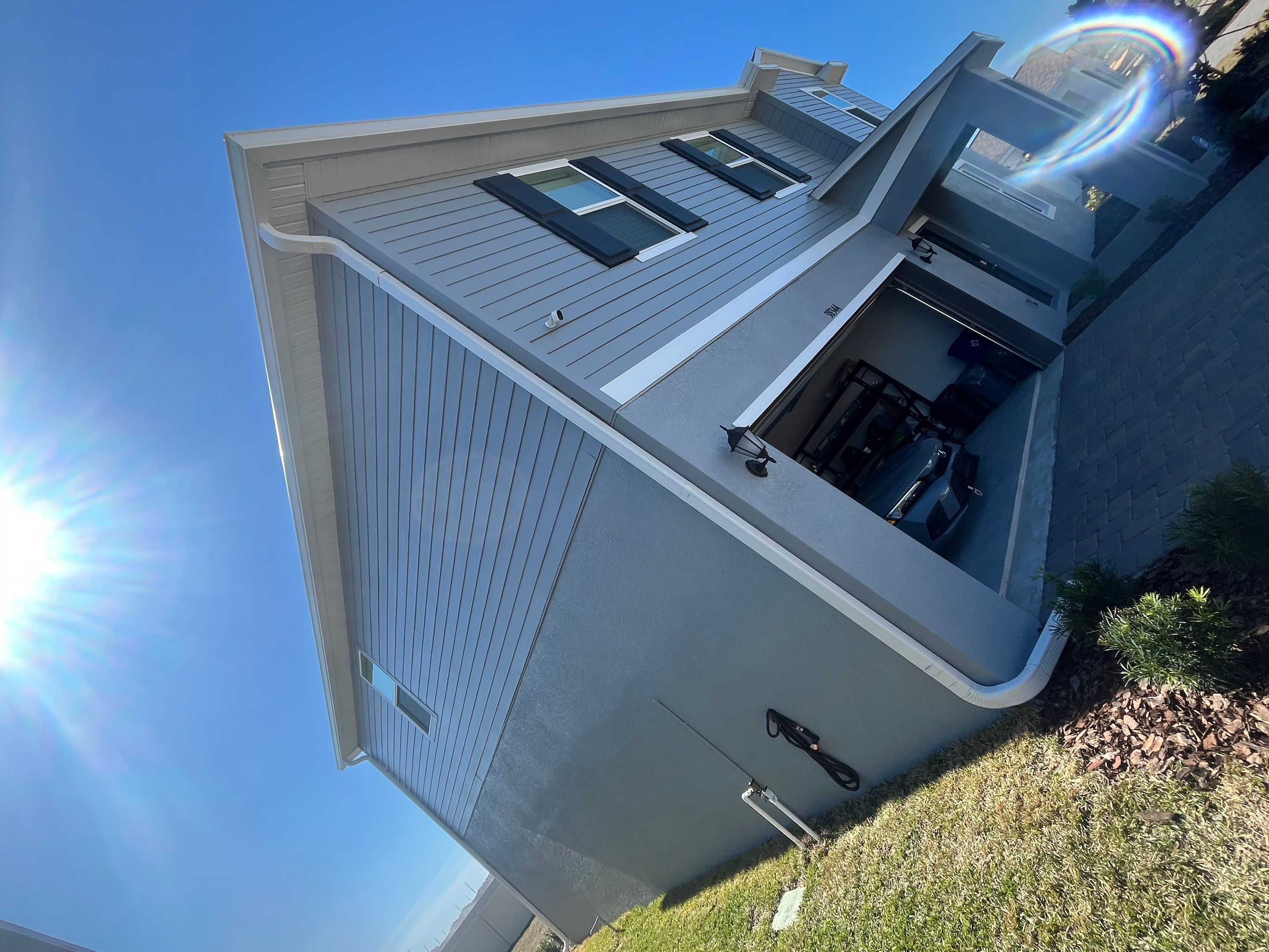 White Down Spouts and Seamless Gutters using downspouts in Dade City FL by Gutter Professors