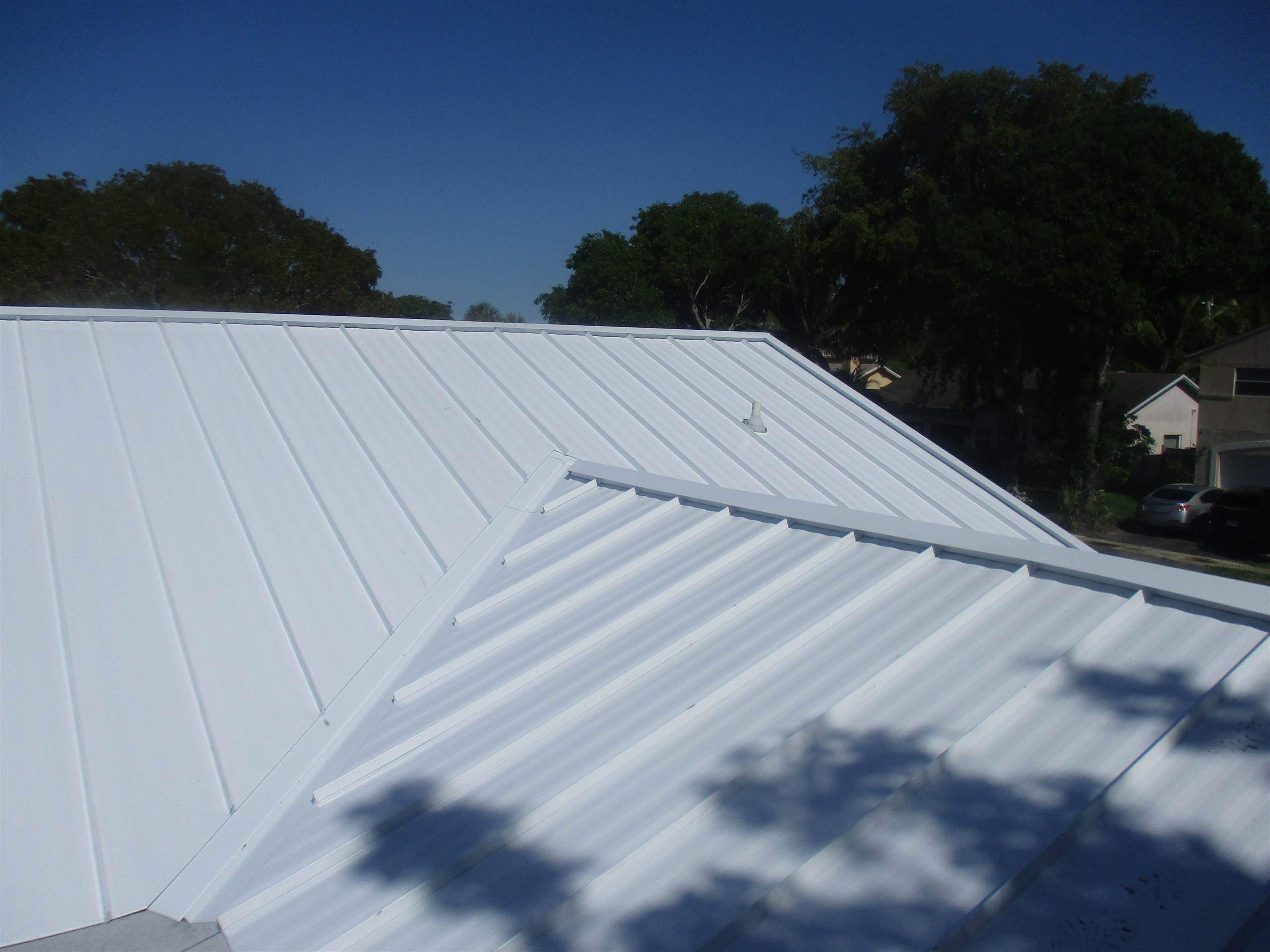 Standing Seam Metal & Flat Re-Roof using 1.5" Nail Strip 24ga Solar White Kynar Coated Standing Seam Metal Panels by Morton Roofing, Inc.