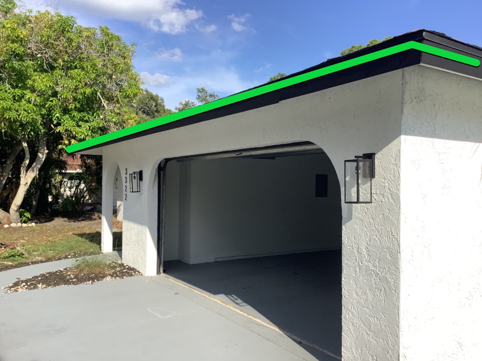 Black seamless gutters and downspouts installation in Sarasota, FL by Gutter Professors