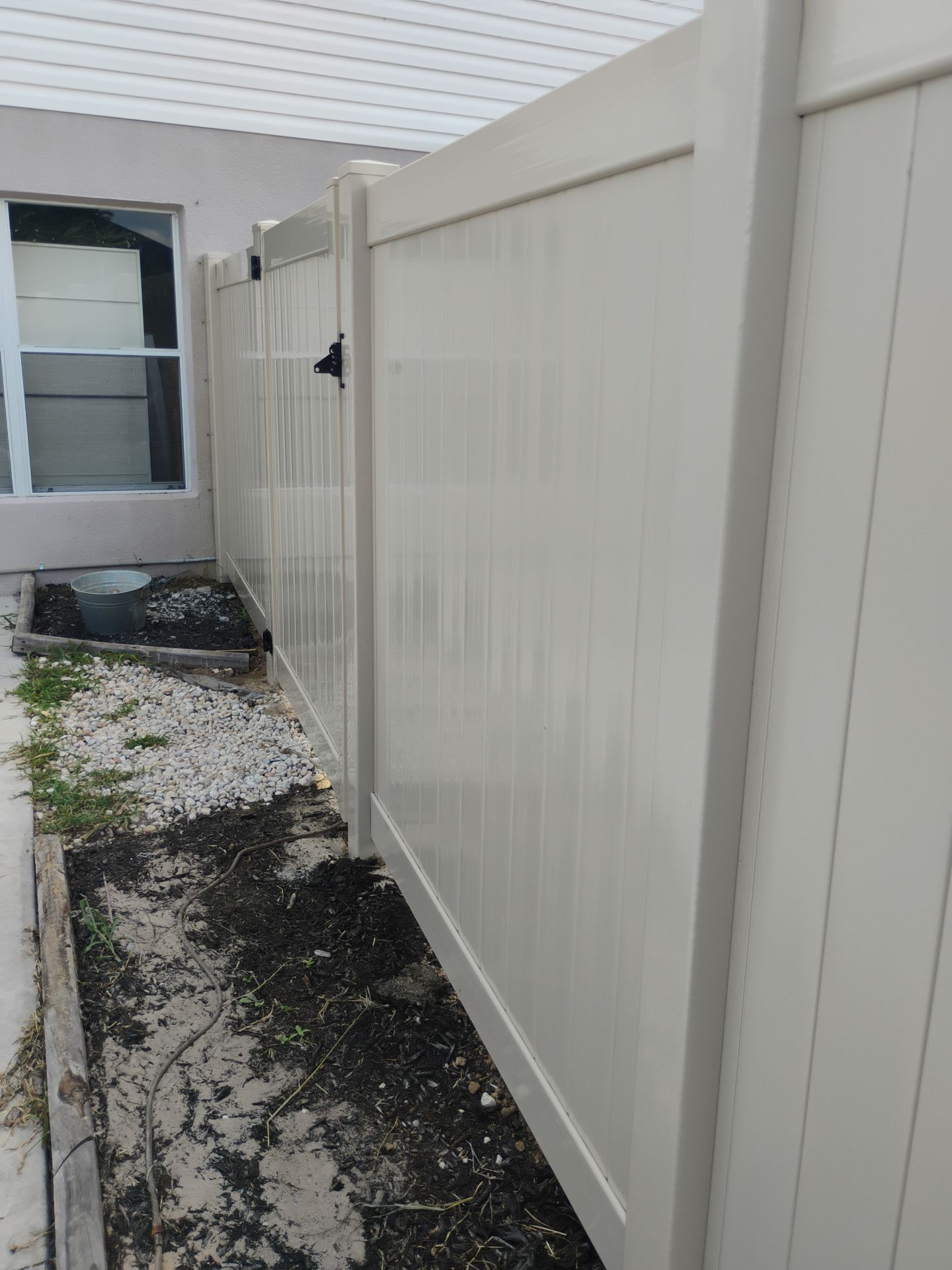 Tan Vinyl Privacy Fence and Gate Installation in North Port by True Fence LLC