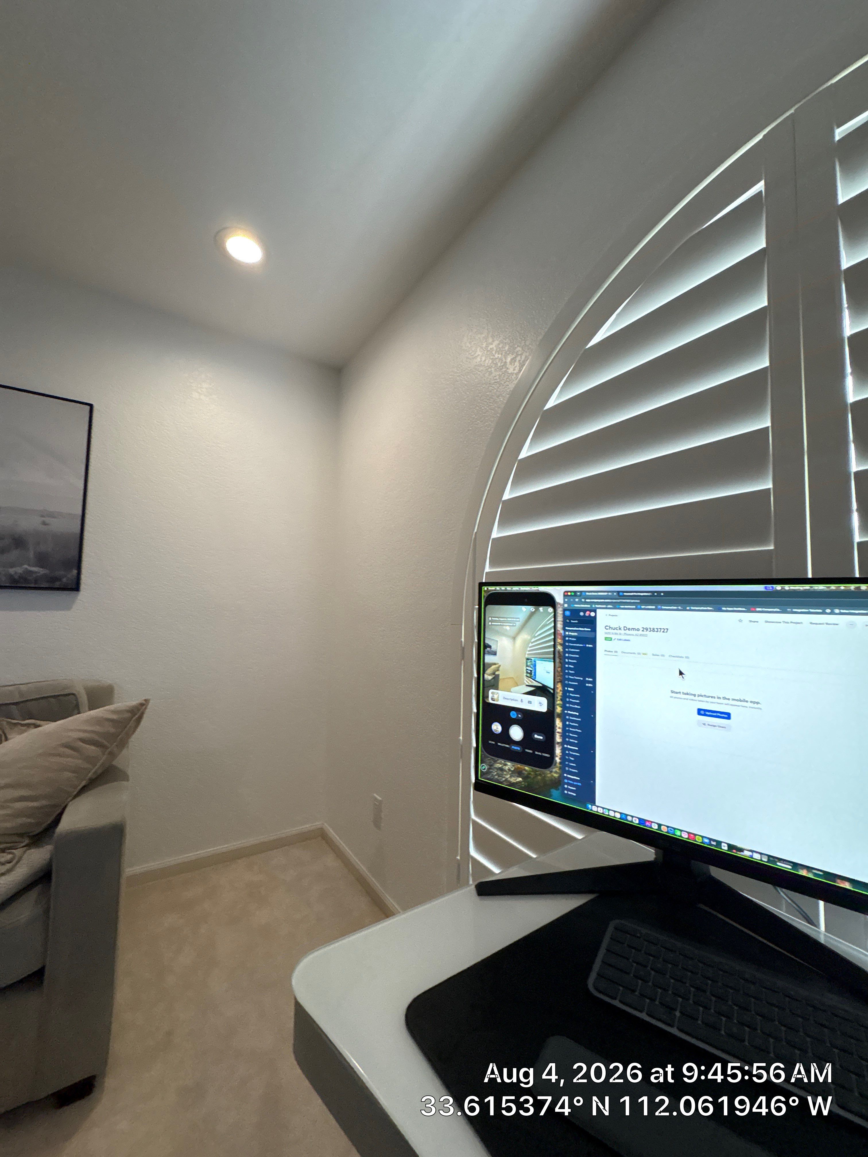 Custom Home Office Setup Featuring Arched Plantation Shutters and Accent Wall by CompanyCam Sales Demo