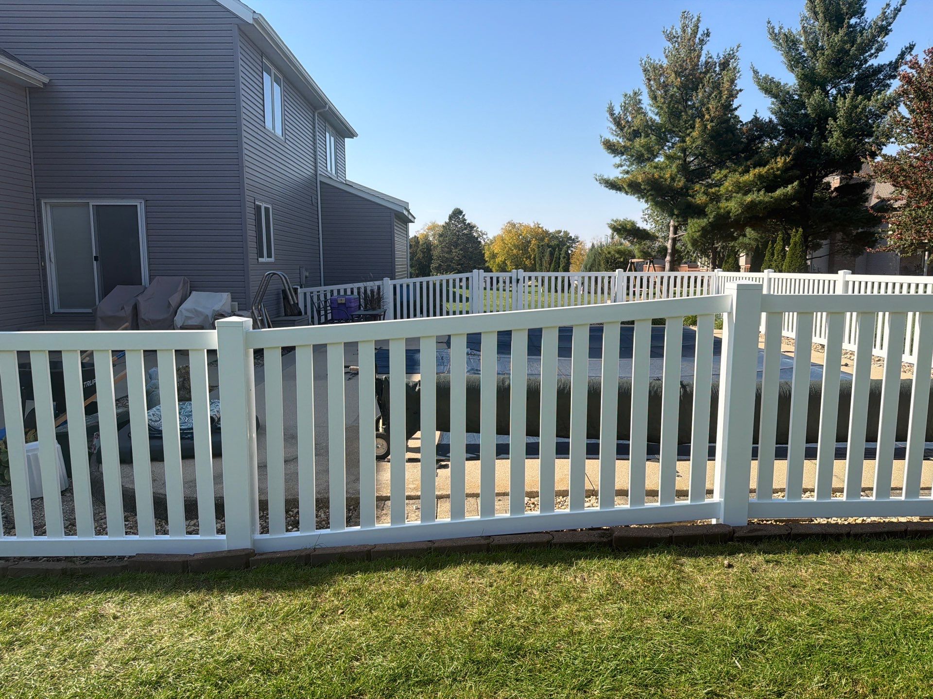 White Vinyl Picket Pool Fence Installation in Waterloo, Iowa by Perfect Picket Fence and Stain