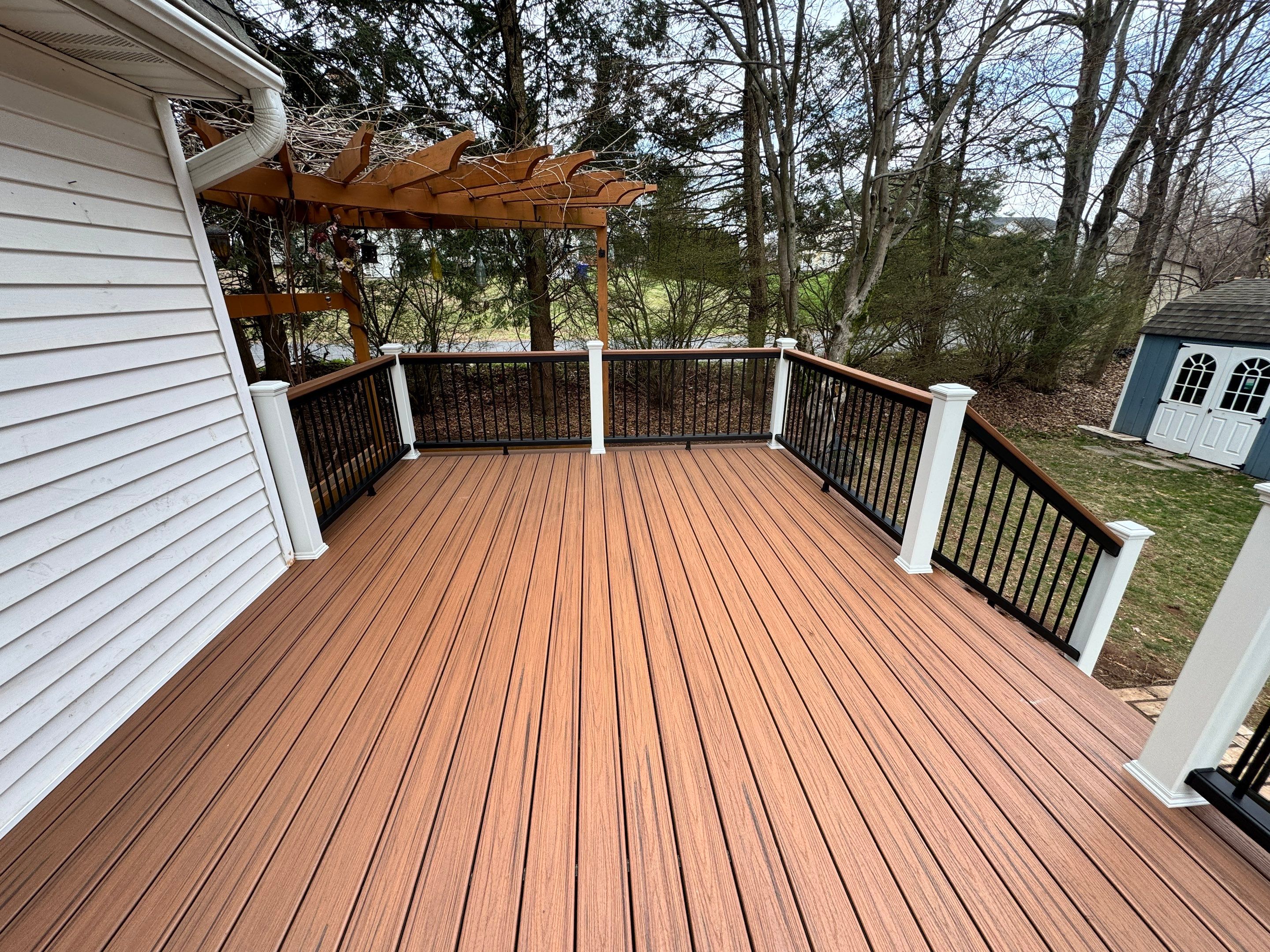 Replacement deck with Trex Transcend Tiki Torch deck boards and matching cocktail rail. by DiGiorgi Roofing and Siding Inc