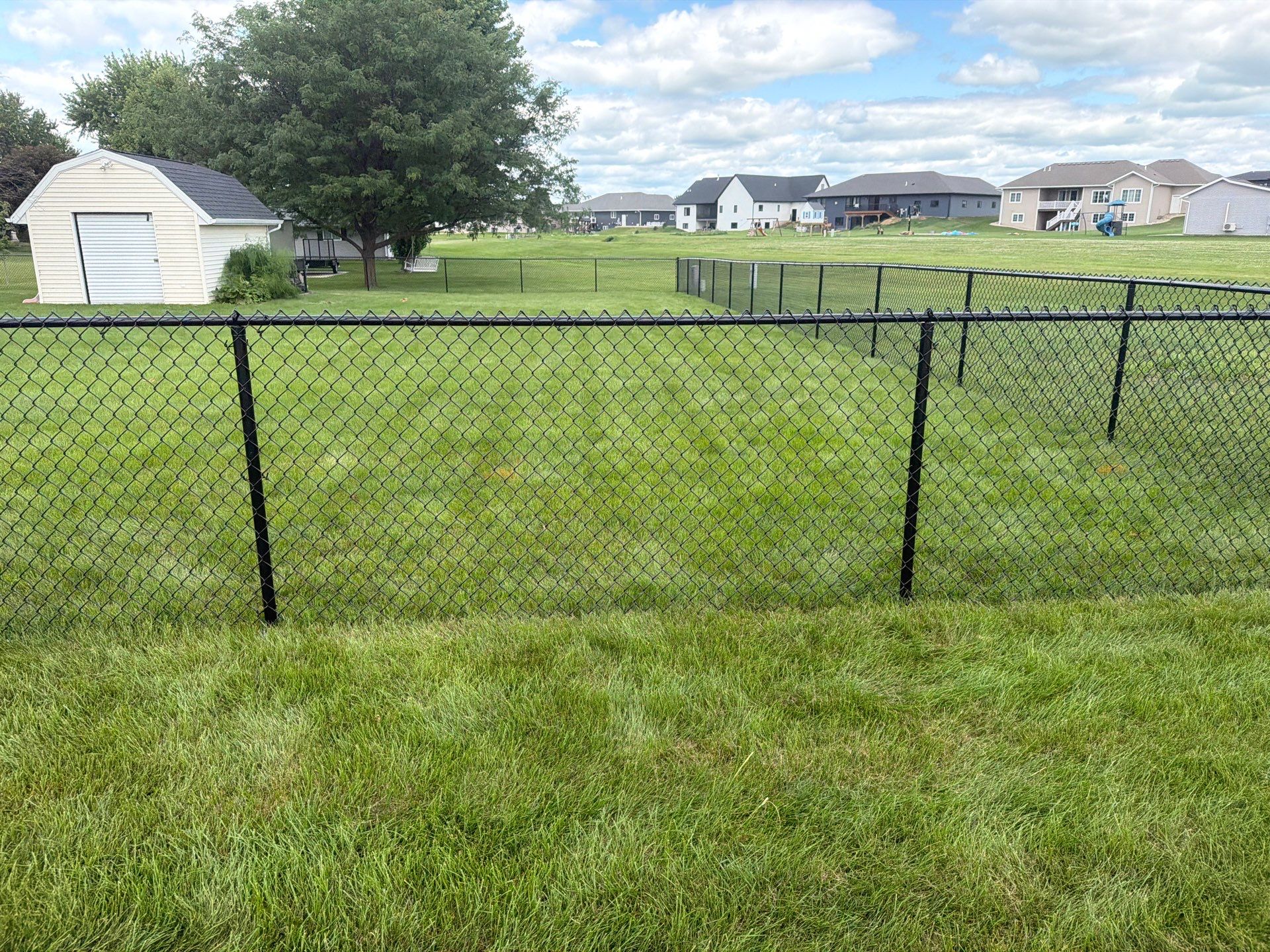 Black Vinyl-Coated Chain Link Fence Installation in Fairbank by Perfect Picket Fence and Stain