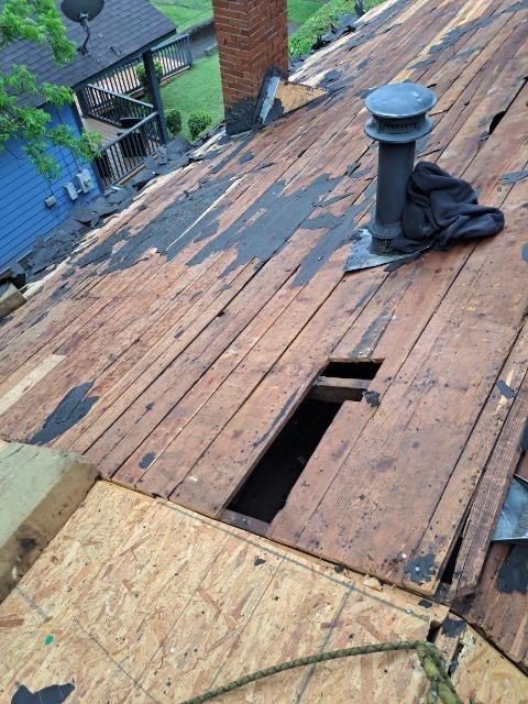 roof replacement and new black gutters by Nailed It Roofing & Remodeling LLC