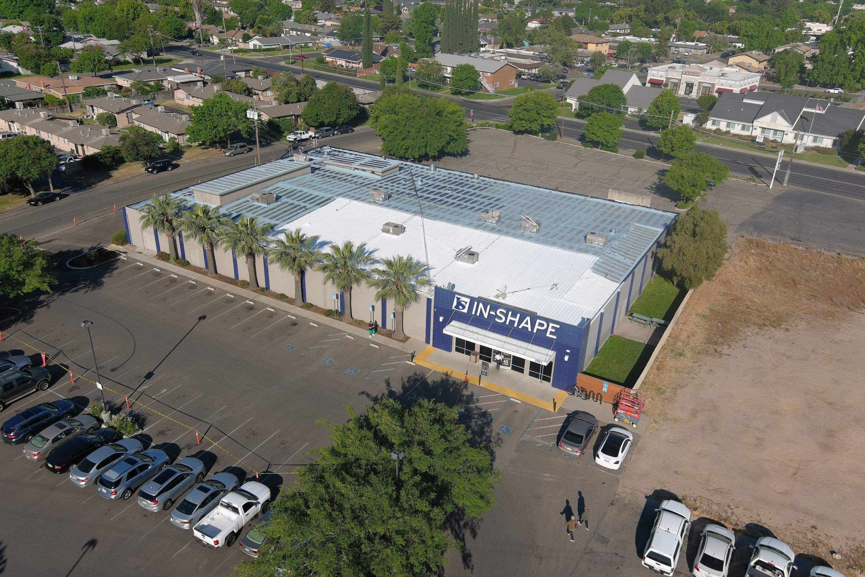 Metal roof restoration on commercial roof using Conklin Benchmark/ PUMA XL acrylic coatings over metal and foam by Straight Edge Roofing Inc