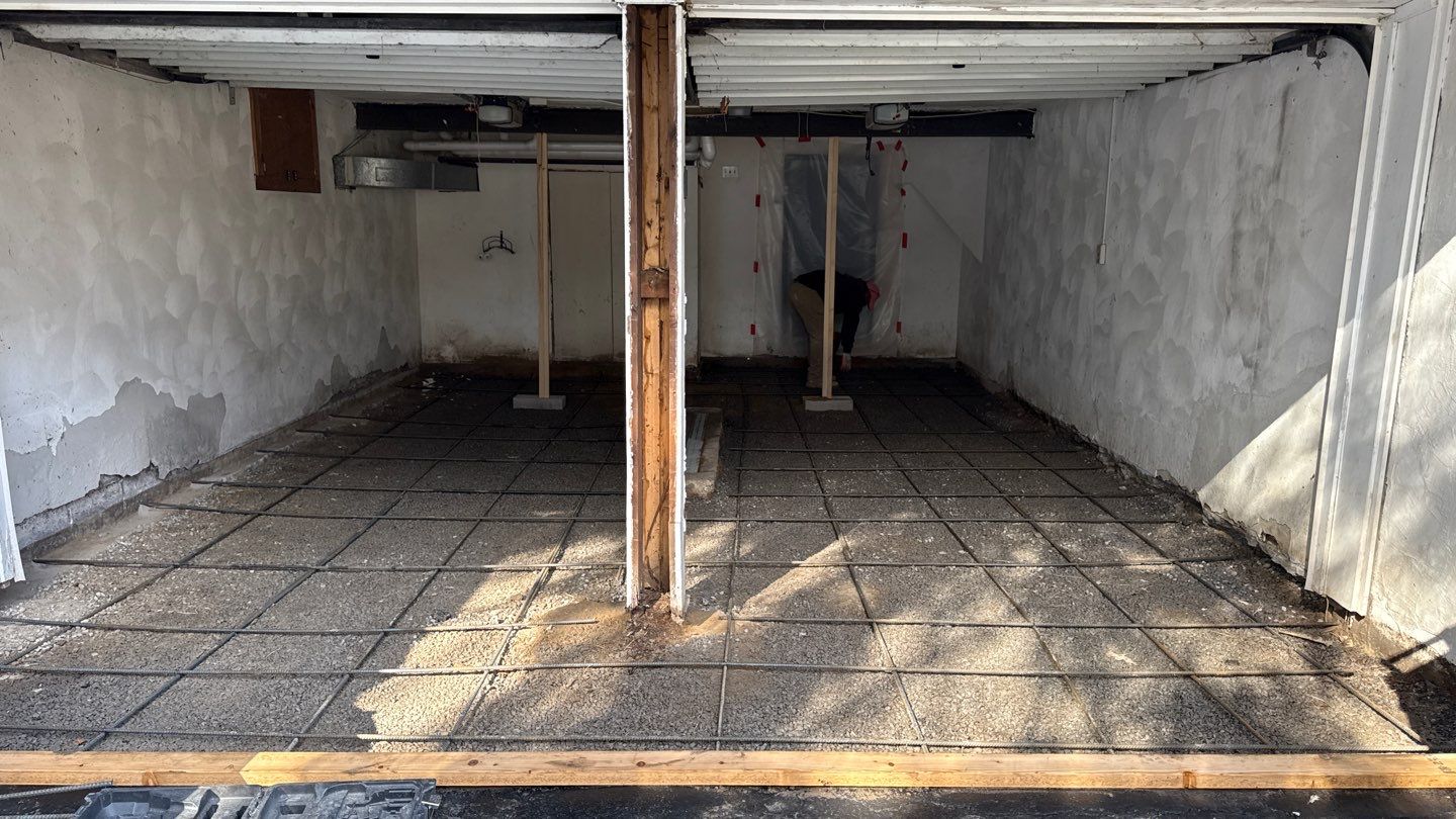 Concrete garage floor replacement with a broom finished apron and wall repair by NG Masonry & Construction LLC