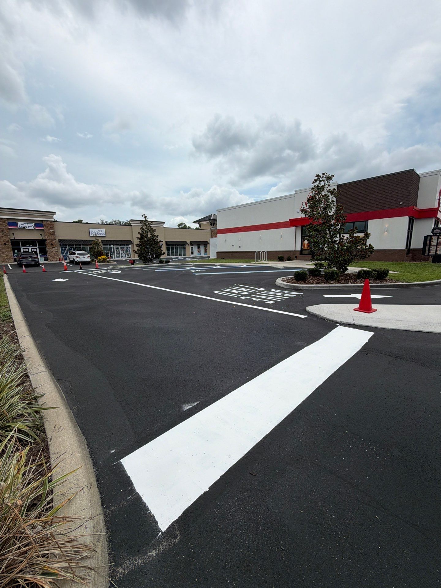 Commercial Asphalt Sealcoating and Line Striping at School House Plaza by Everline Coatings & Services - Southwest FL