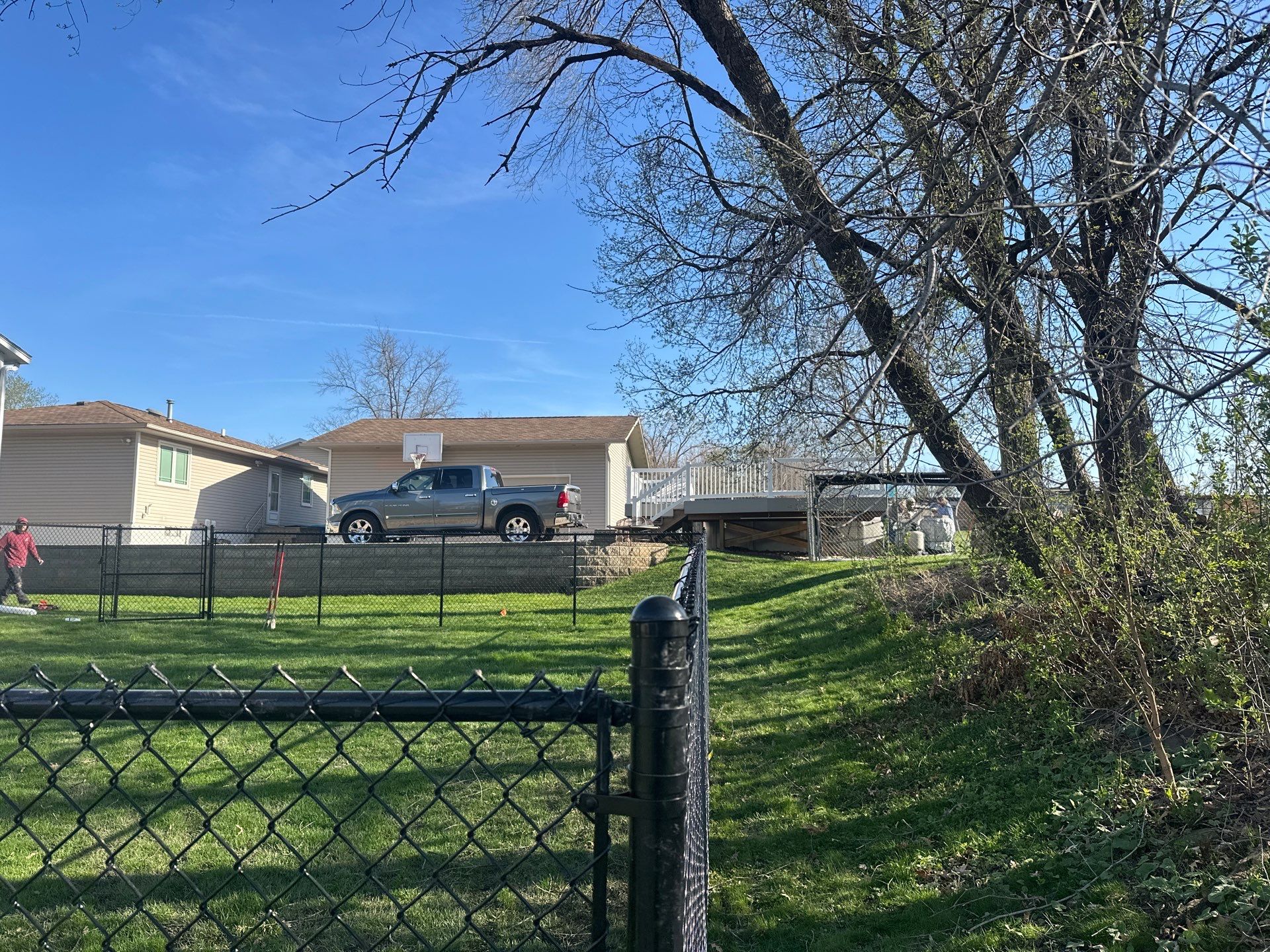Black Vinyl-Coated Chain Link Fence Installation in Waterloo by Perfect Picket Fence and Stain
