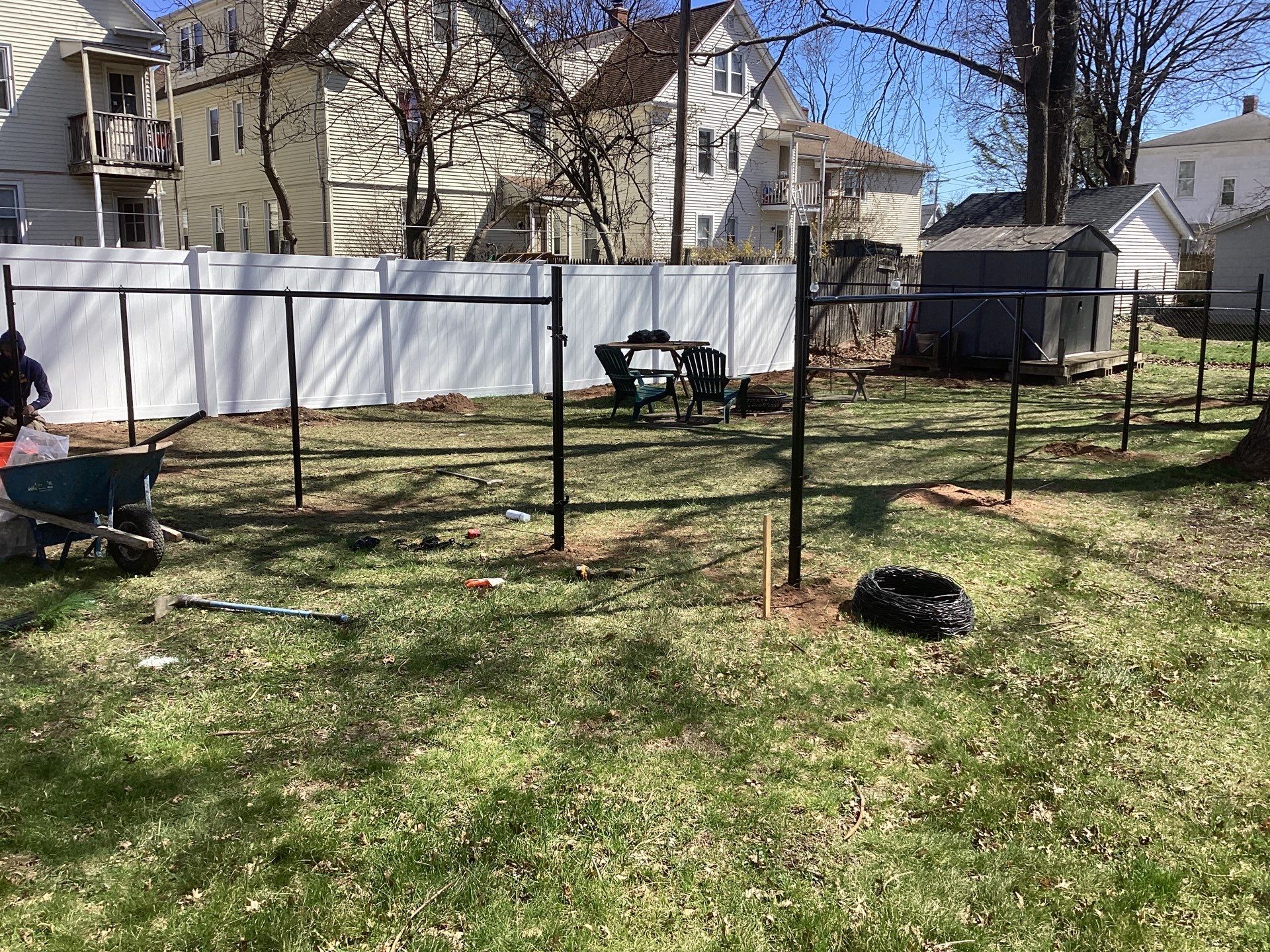 New Black Chain link and White Vinyl privacy fence with matching chain link gate. by DiGiorgi Roofing and Siding Inc