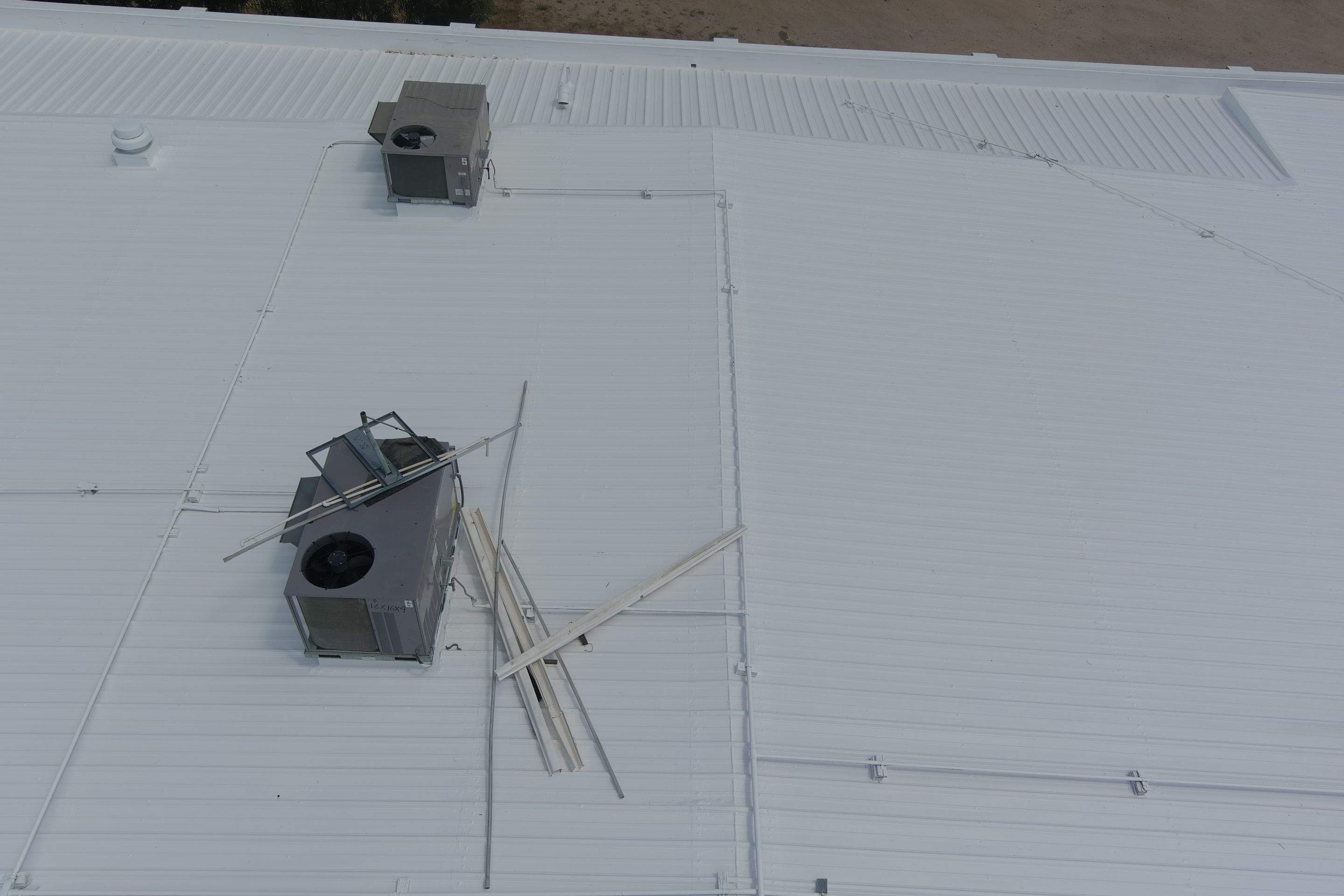 Metal roof restoration on commercial roof using Conklin Benchmark/ PUMA XL acrylic coatings over metal and foam by Straight Edge Roofing Inc