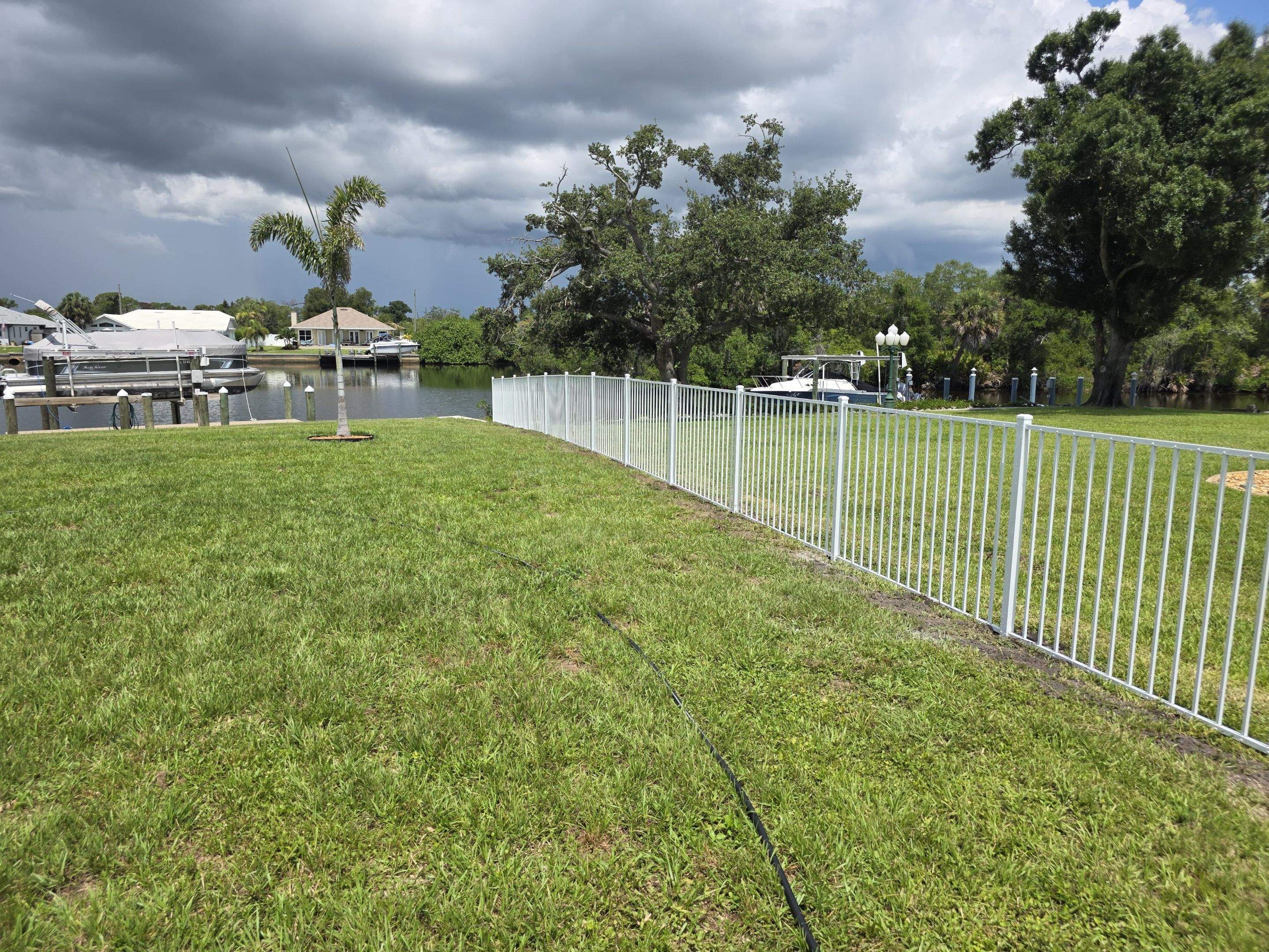 White Aluminum Picket Fence Installation for Port Charlotte Waterfront Home by True Fence LLC