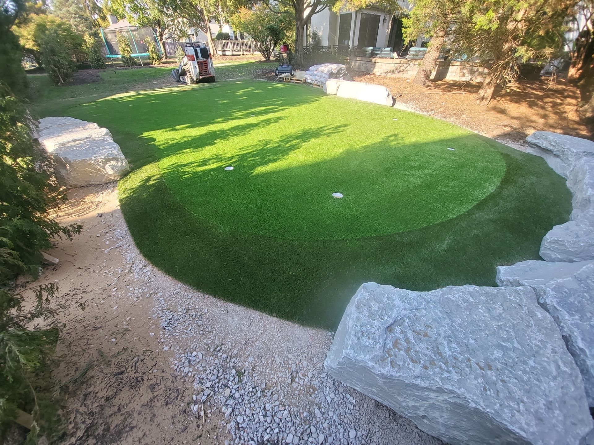Custom Backyard Putting Green around Landscape Boulders in Hilliard by Southwest Greens Midwest
