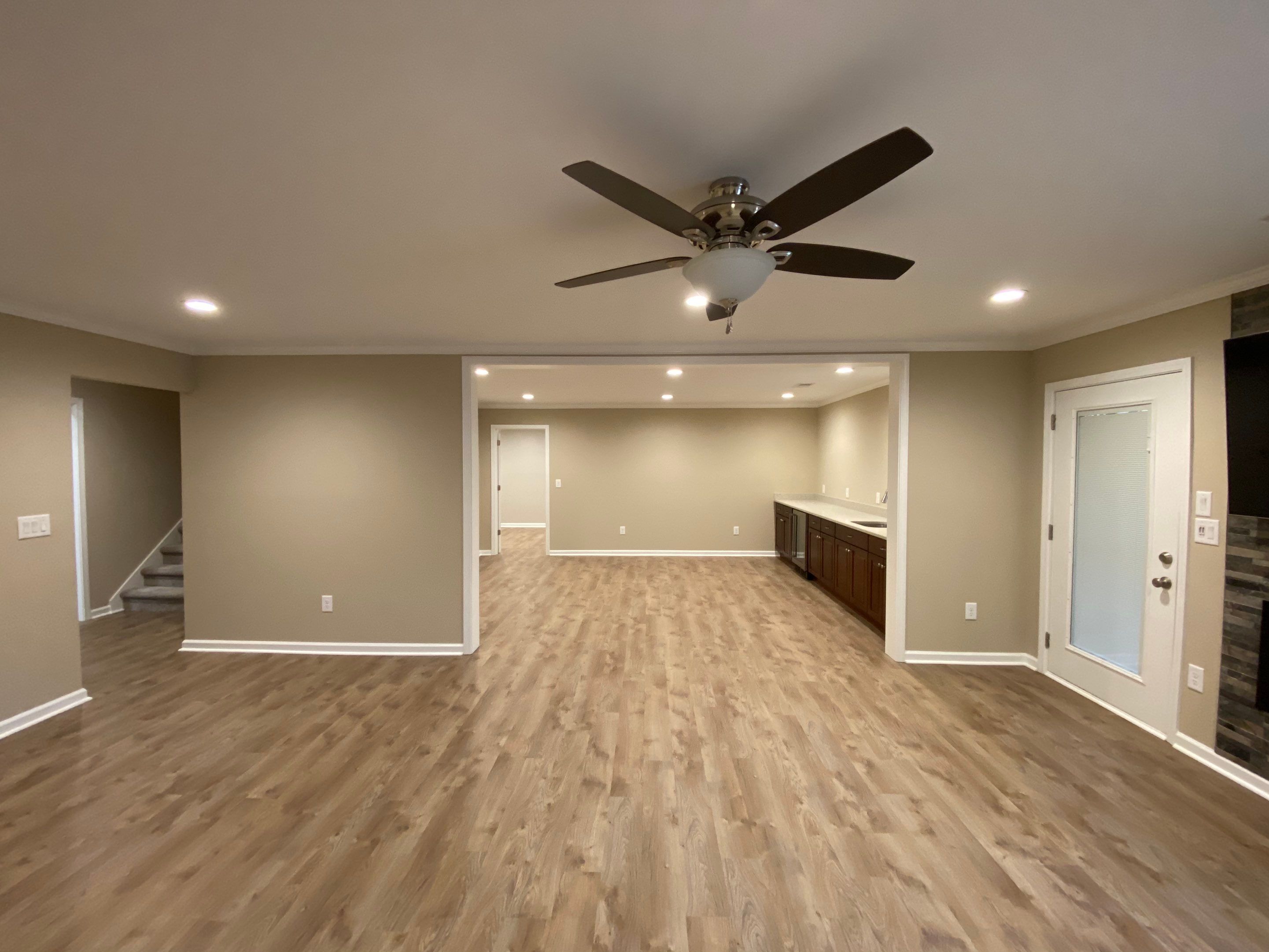 Acworth Basement Transformation With Wet Bar and Stone Fireplace by Swift Home Renovations