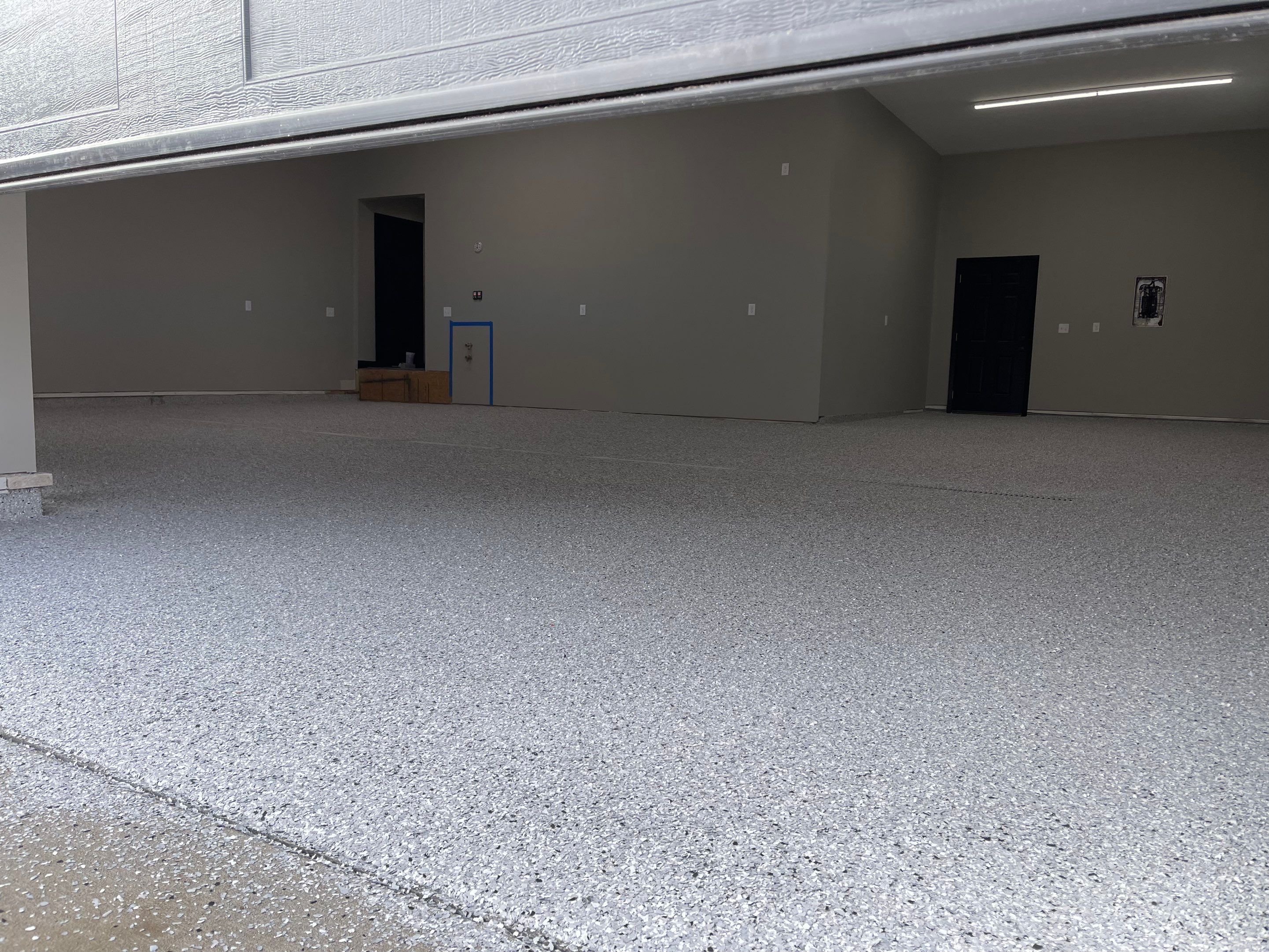 Decorative Flake Concrete Coating Installation in North Sioux City by Select Painting, Coatings & Garage Cabinets