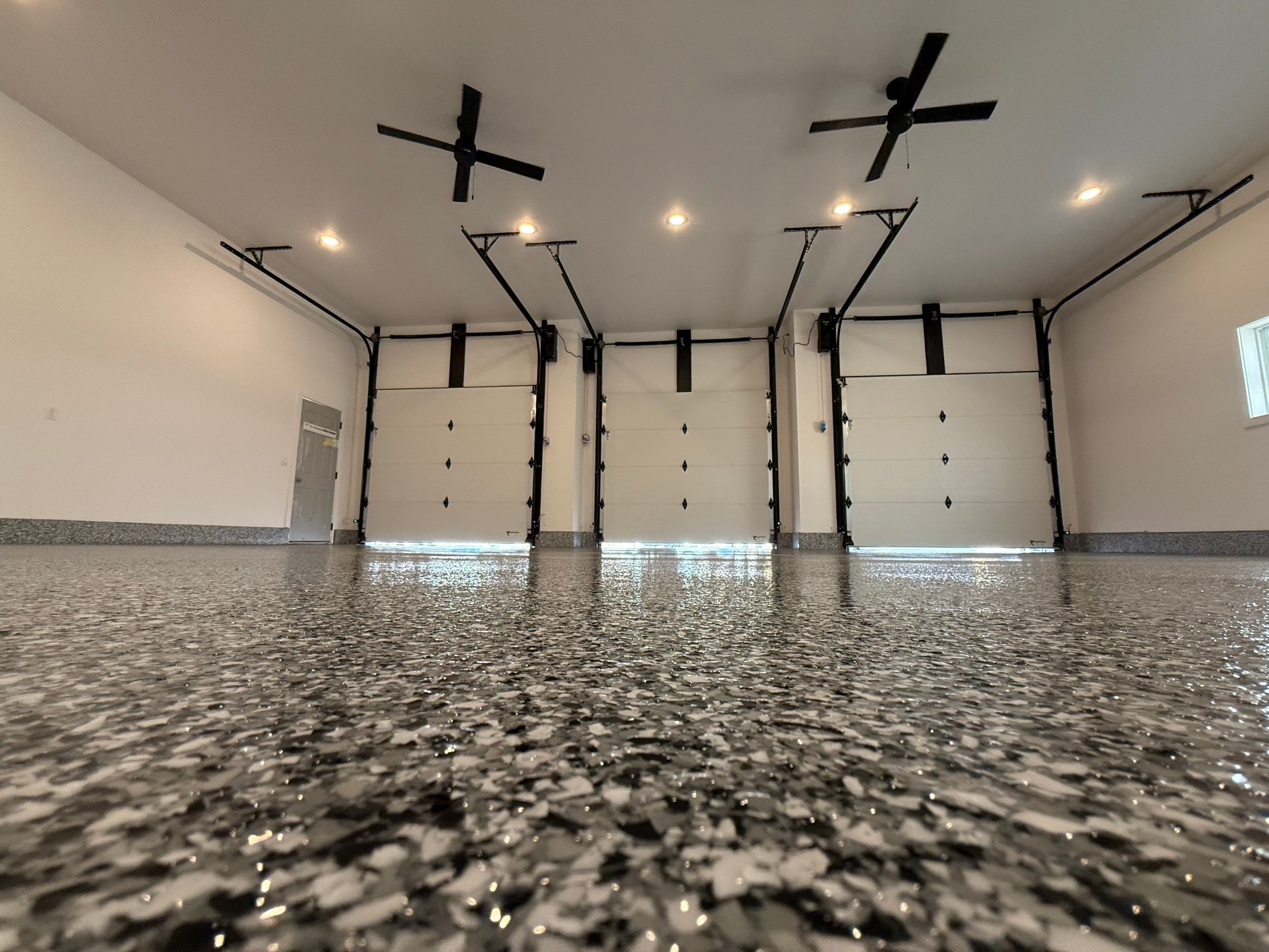 Multi-Car Garage Epoxy Floor Coating and Concrete Finishing in Sioux Falls by Select Painting, Coatings & Garage Cabinets