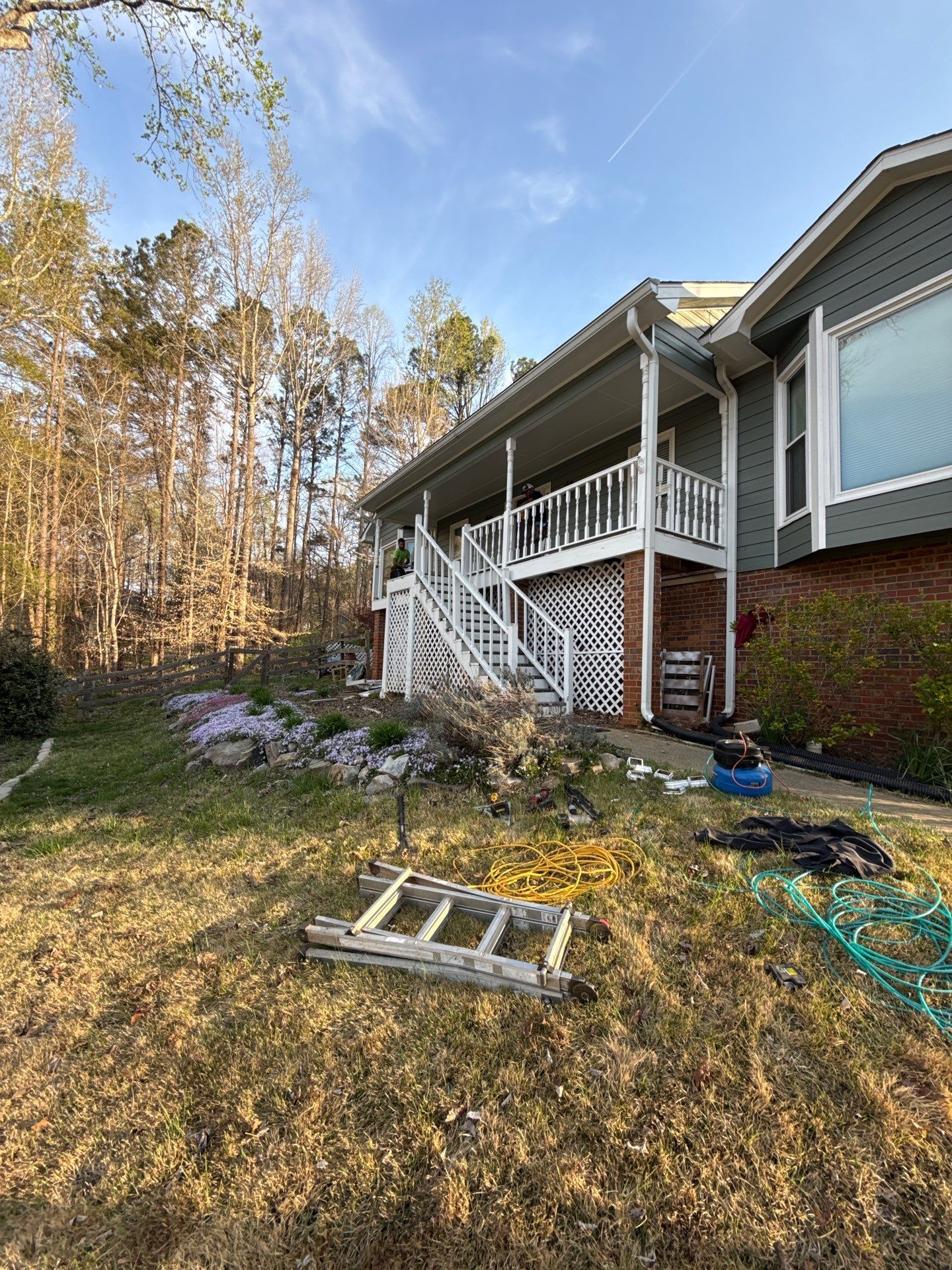 Composite Deck and Porch Renovation With Black Metal Railings by Swift Home Renovations 