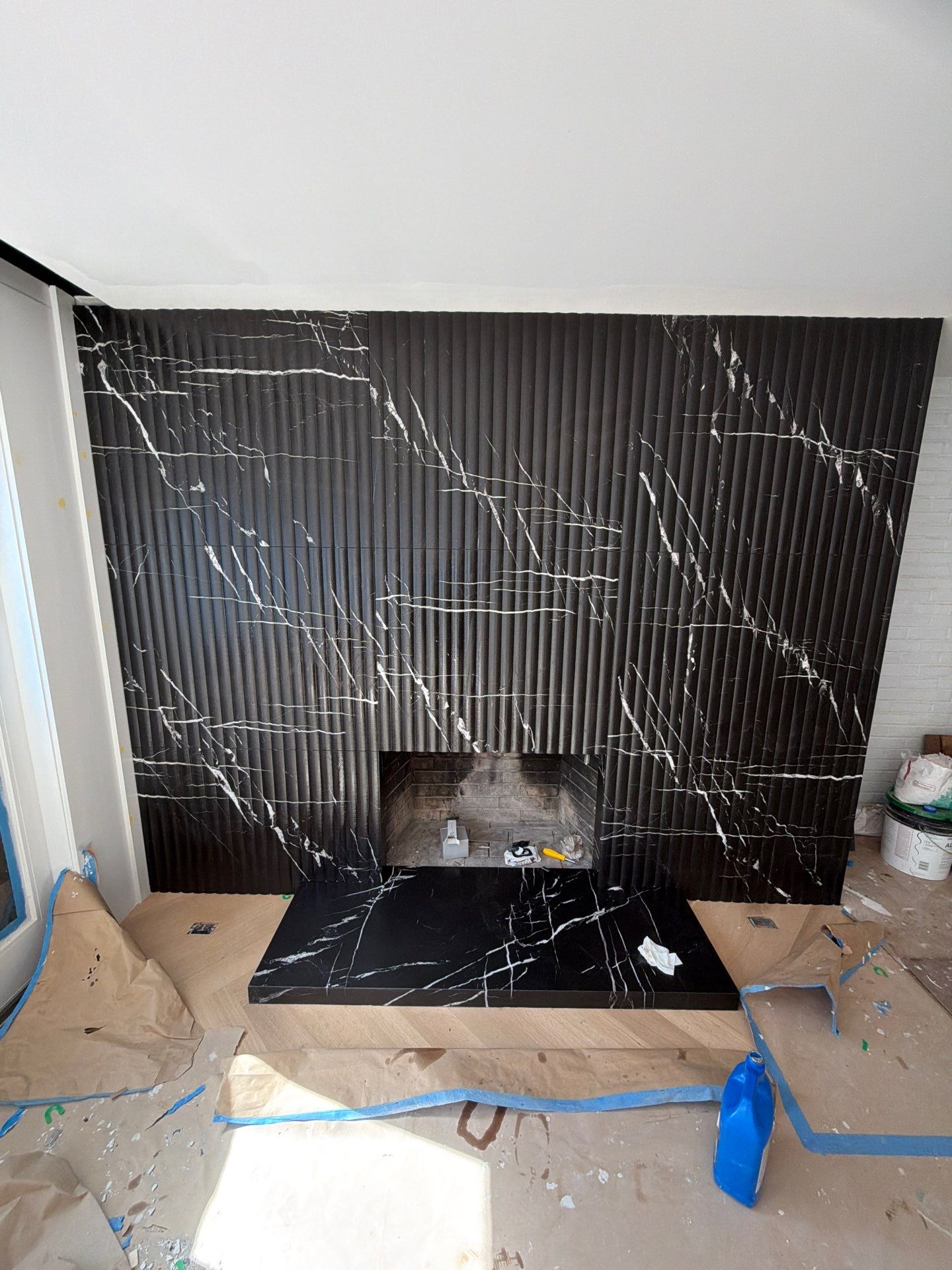 Full-Height Fluted Marble Fireplace Wall by NC Stone And Tiles