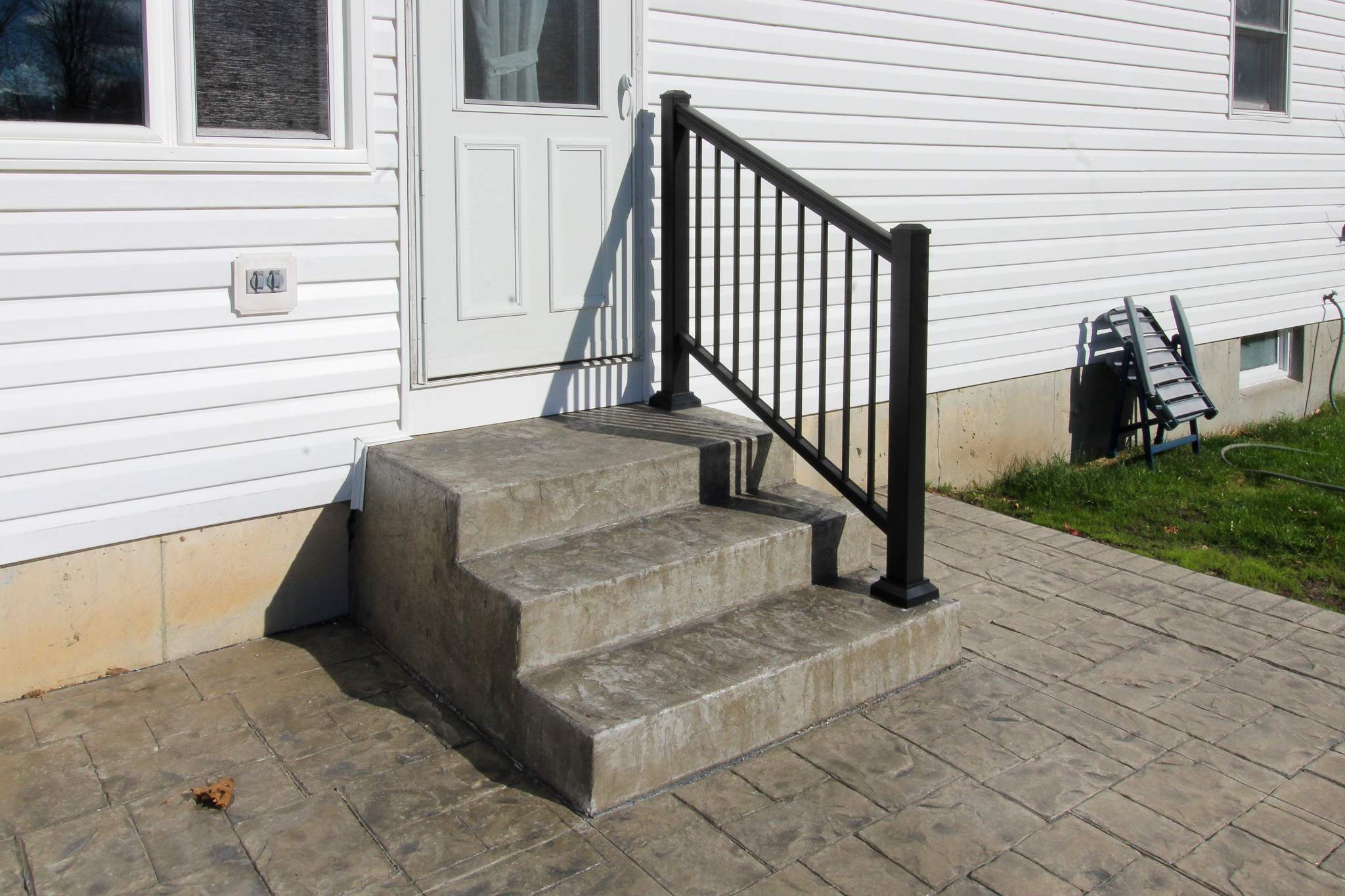 Stamped Concrete and Entry Door by Ivy Lea Construction