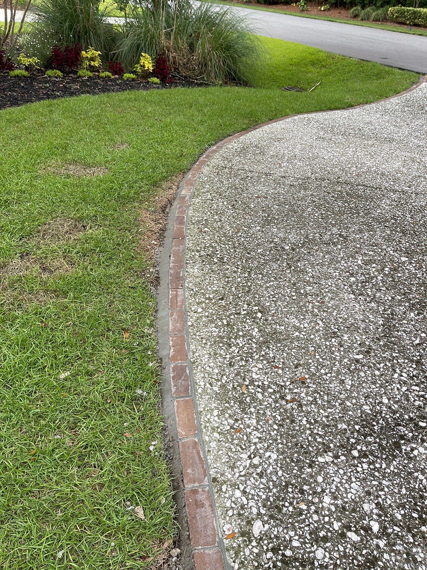 Custom Exposed Aggregate Driveway with Red Brick Borders in Hilton Head Island by Lowcountry Scapes, LLC