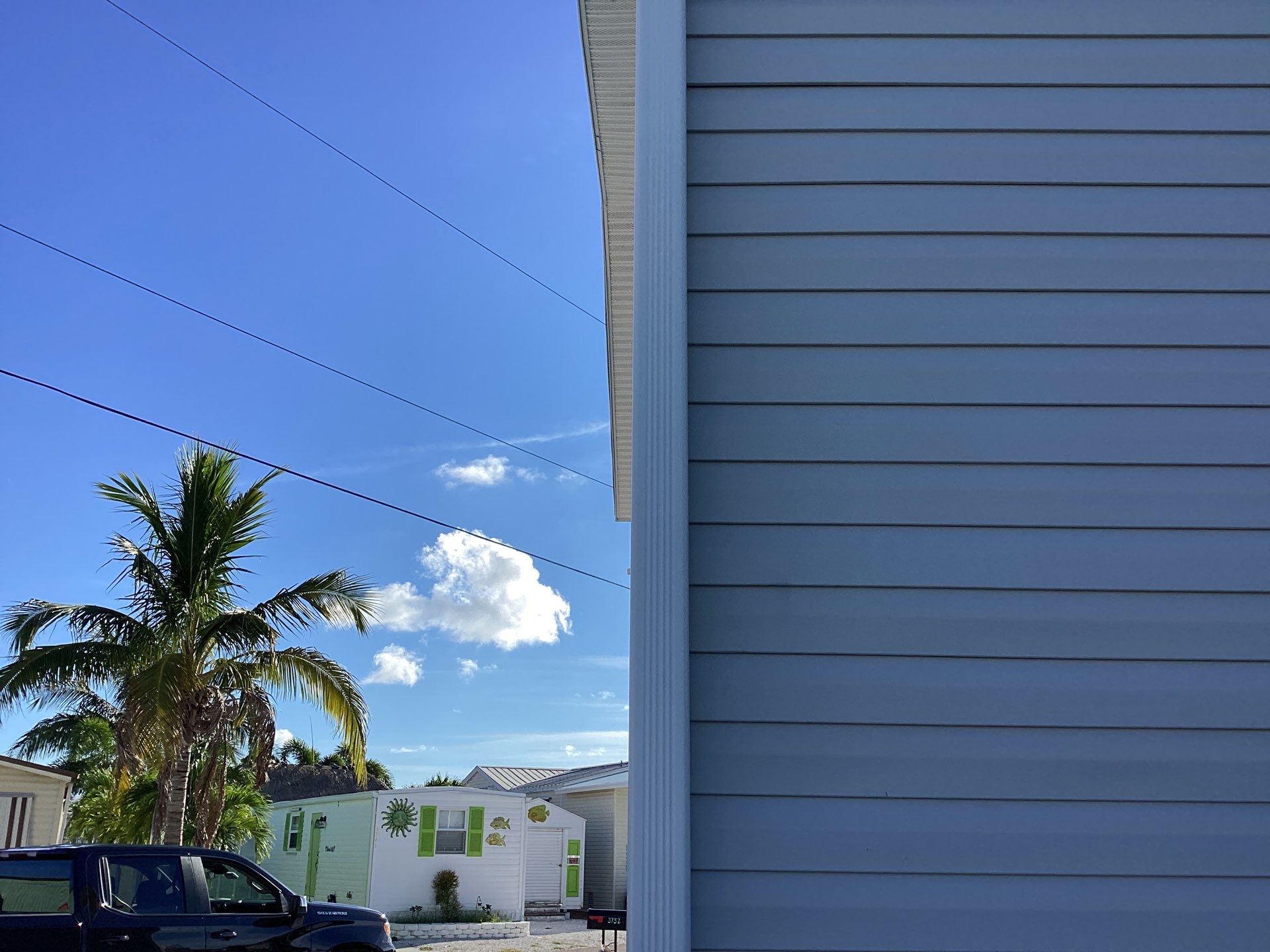 White Downspouts Installation in St. James City by Gutter Professors