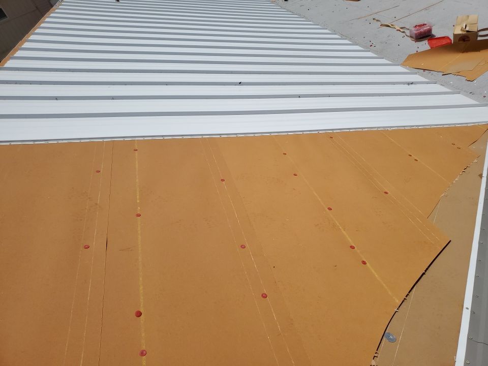 Residential Roofing Installation using 1.5" Nail Strip 24ga Solar White Kynar Coated Standing Seam Metal Panels by Morton Roofing, Inc.