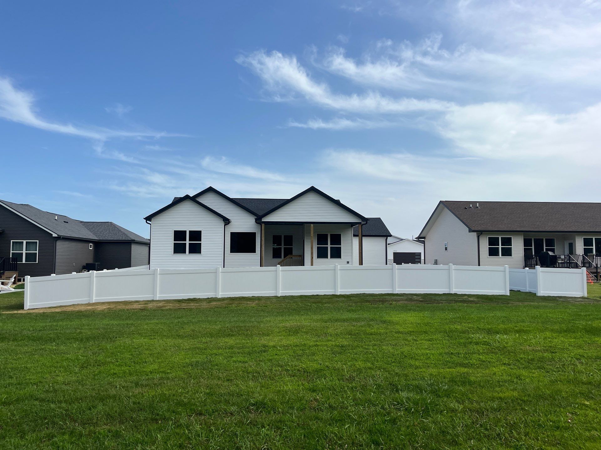 White Vinyl Privacy Fence With Pet Window in Cedar Falls by Perfect Picket Fence and Stain