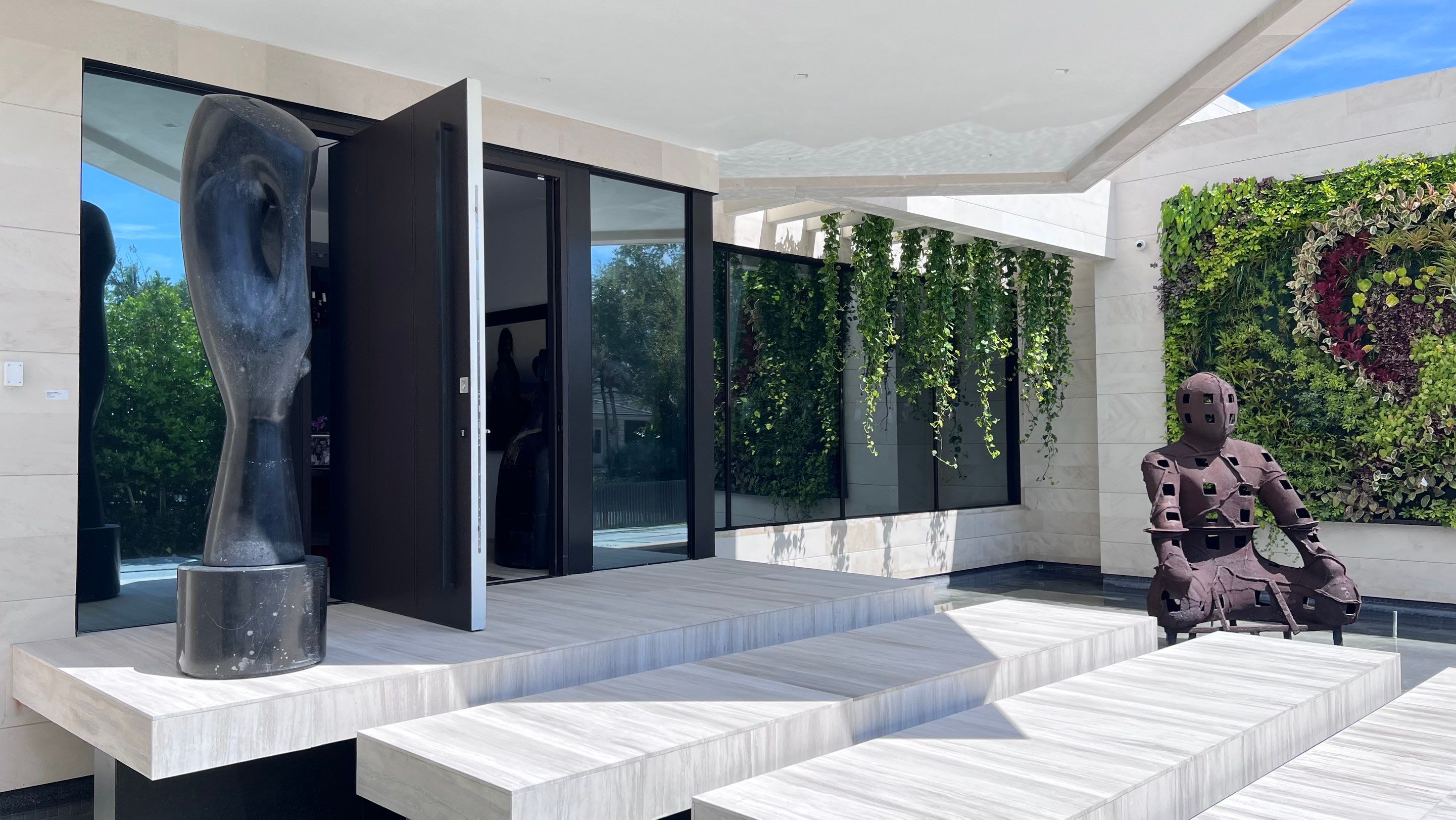 Custom Material Pivot Door installation by Impact Precious Wood Inc.