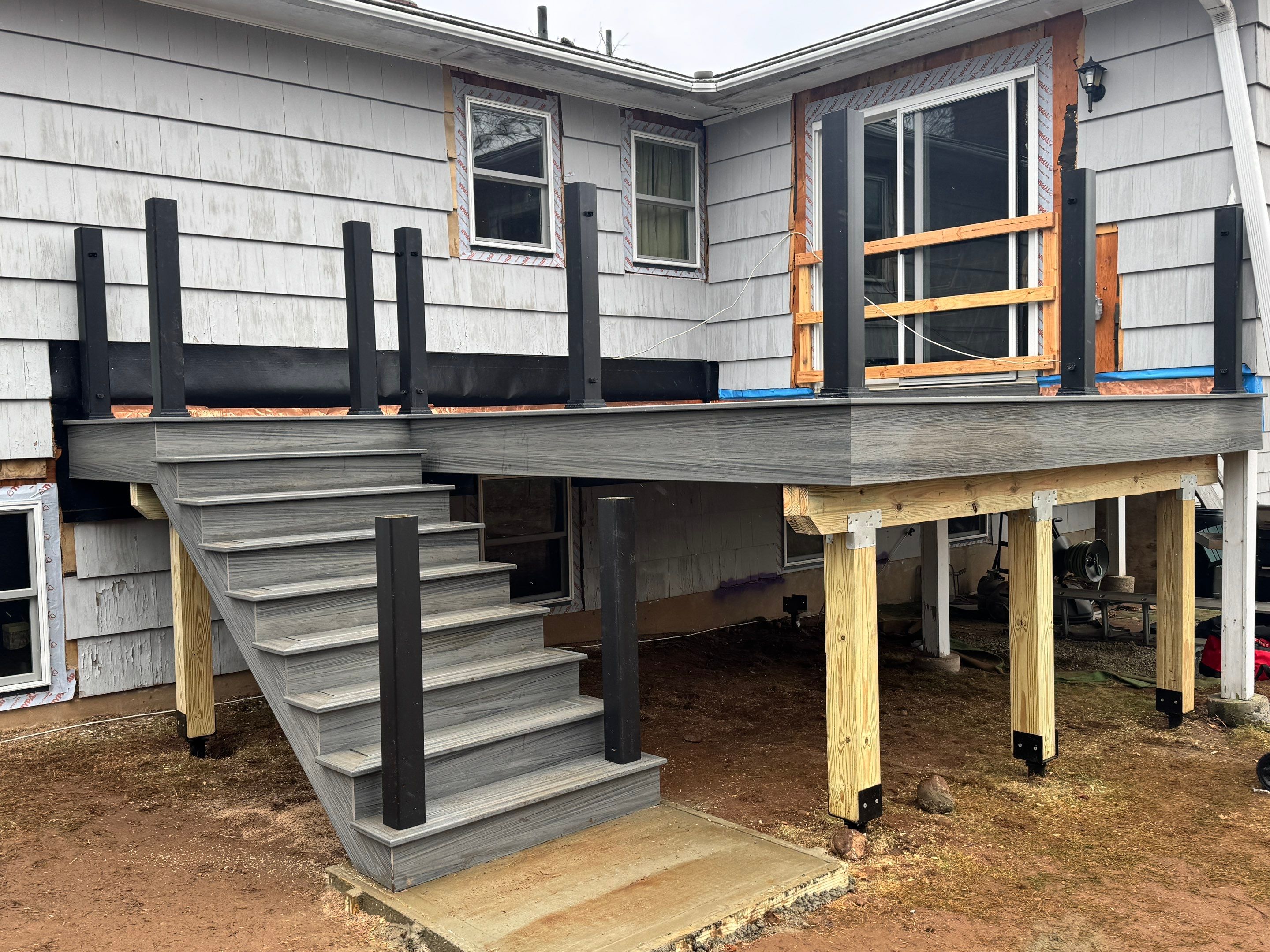 New Deck, Trex Tropical Island mist boards and Fascia. Black composite trex railing. by DiGiorgi Roofing and Siding Inc