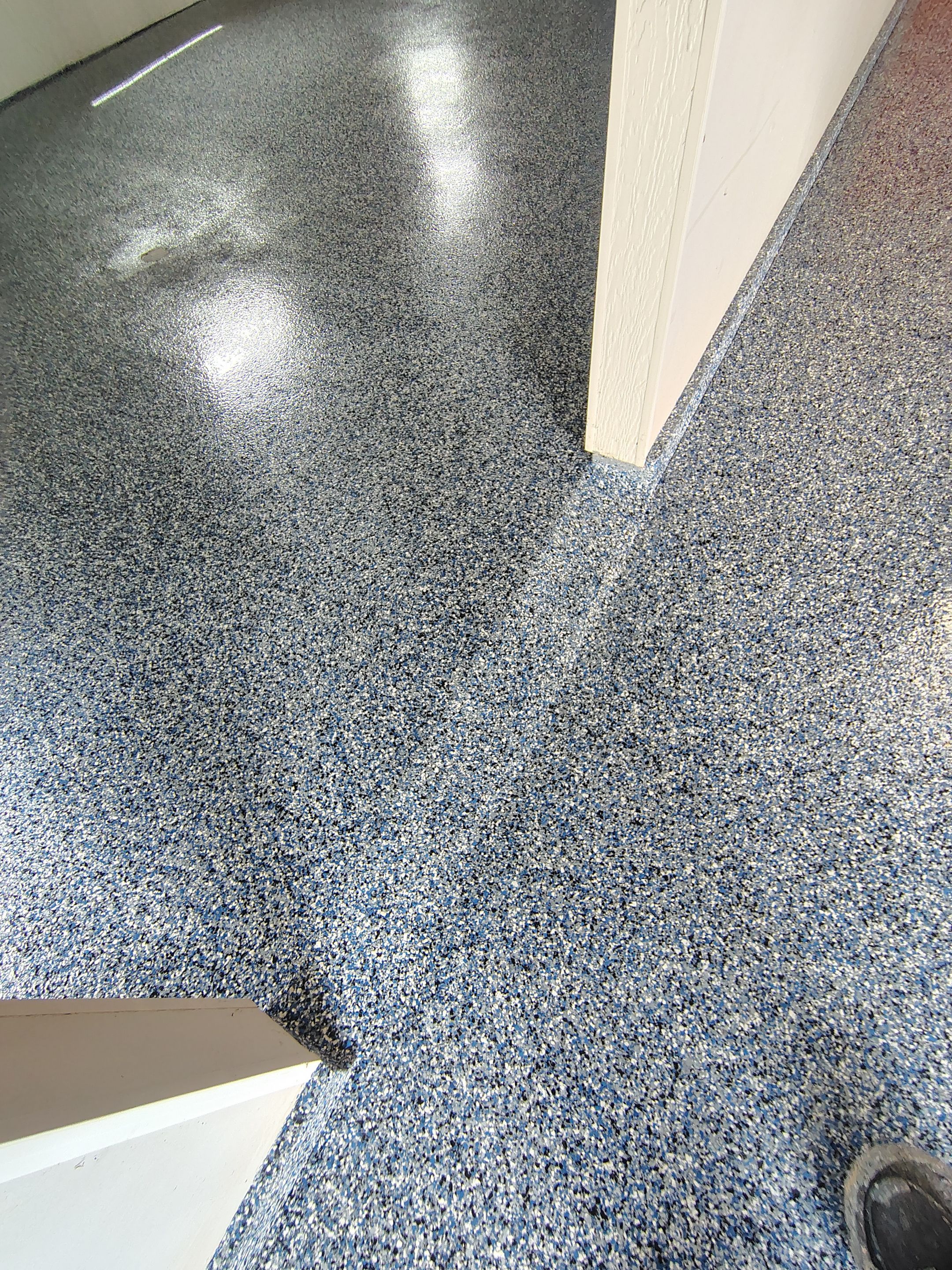 Custom Grey Flake Epoxy Garage Floor Installation in Remsen by Select Painting, Coatings & Garage Cabinets