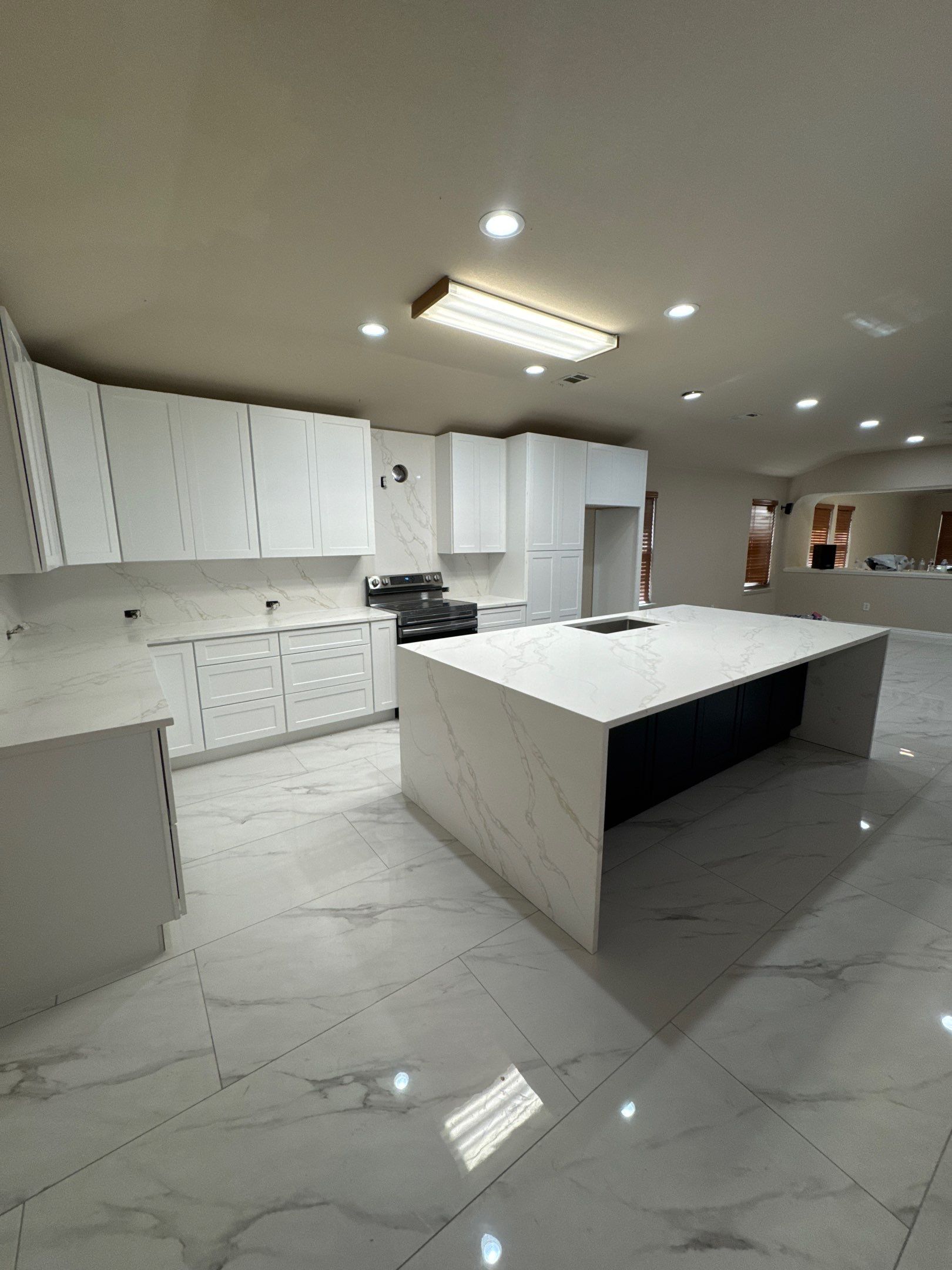 Luxury Focal Point: Full Kitchen Remodel with Double Waterfall Island by Tibi Soli LLC