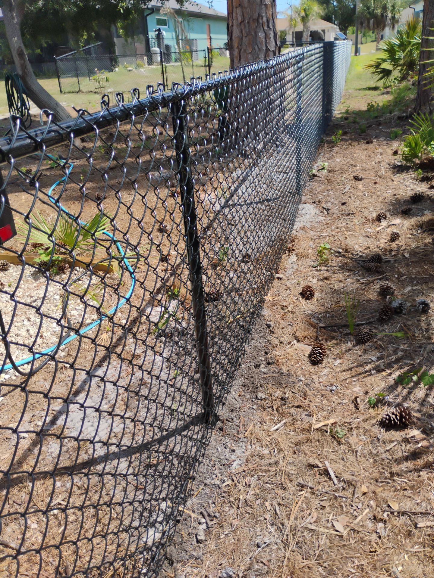 Black Vinyl-Coated Chain Link Fence and Rolling Gate Installation in North Port by True Fence LLC