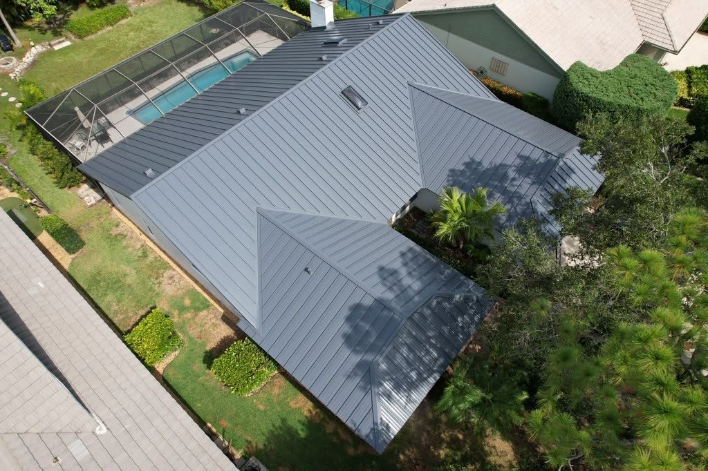 Standing Seam Metal Charcoal Grey Roof Replacement and Skylight Installation in Jupiter by Art's Roofing & Construction