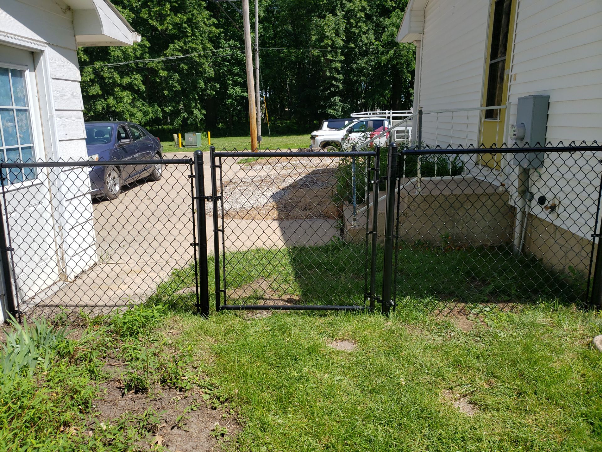 Black Chain Link Perimeter Fence and Gate Installation in Cedar Falls by Perfect Picket Fence and Stain