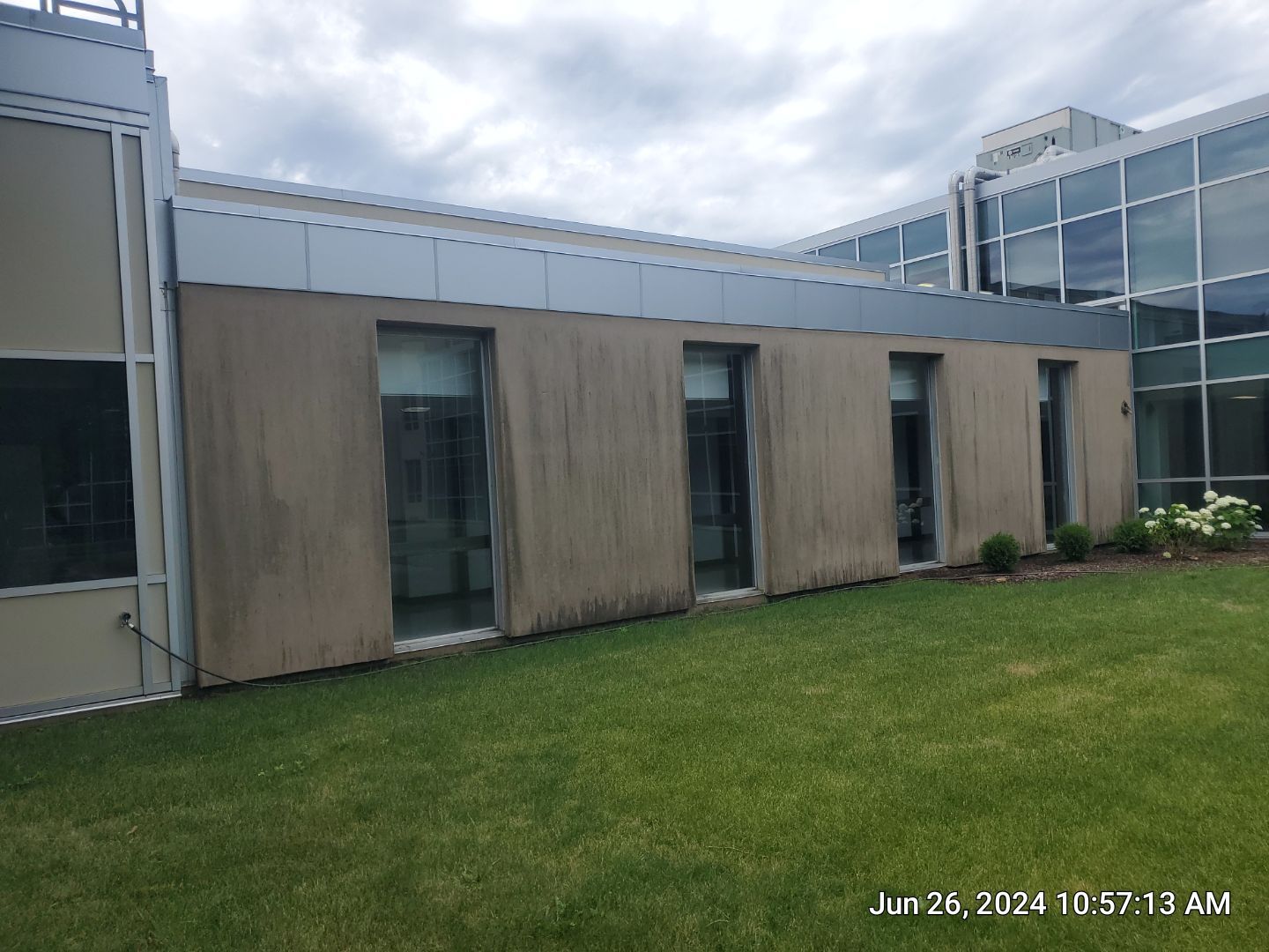 concrete using Algaecide, soft wash soap by Northern Power Washing LLC.