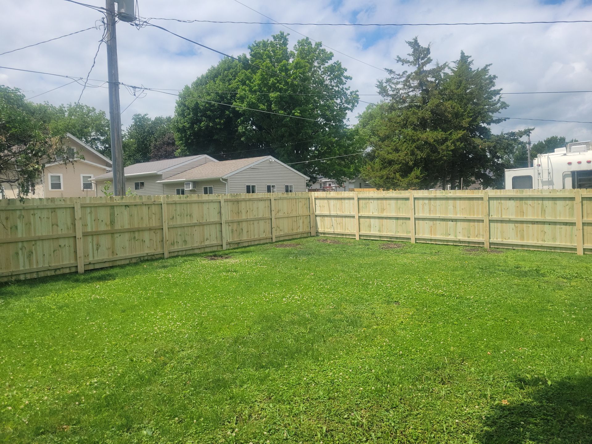 Pressure-Treated Wood Privacy Fence Installation in Charles City by Perfect Picket Fence and Stain